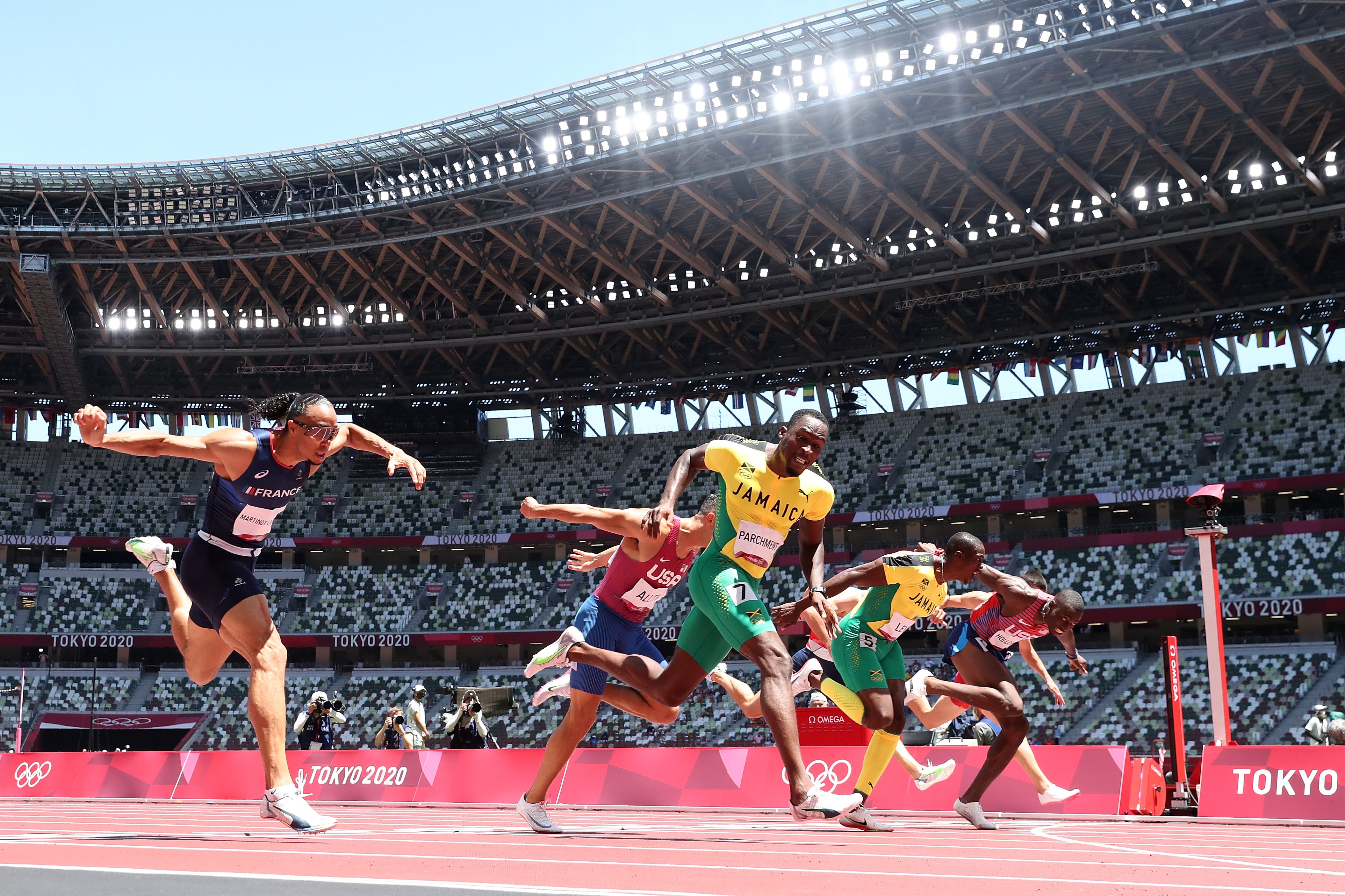 Hansle Parchment, centre picture, beats USA”s Grant Holloway, right