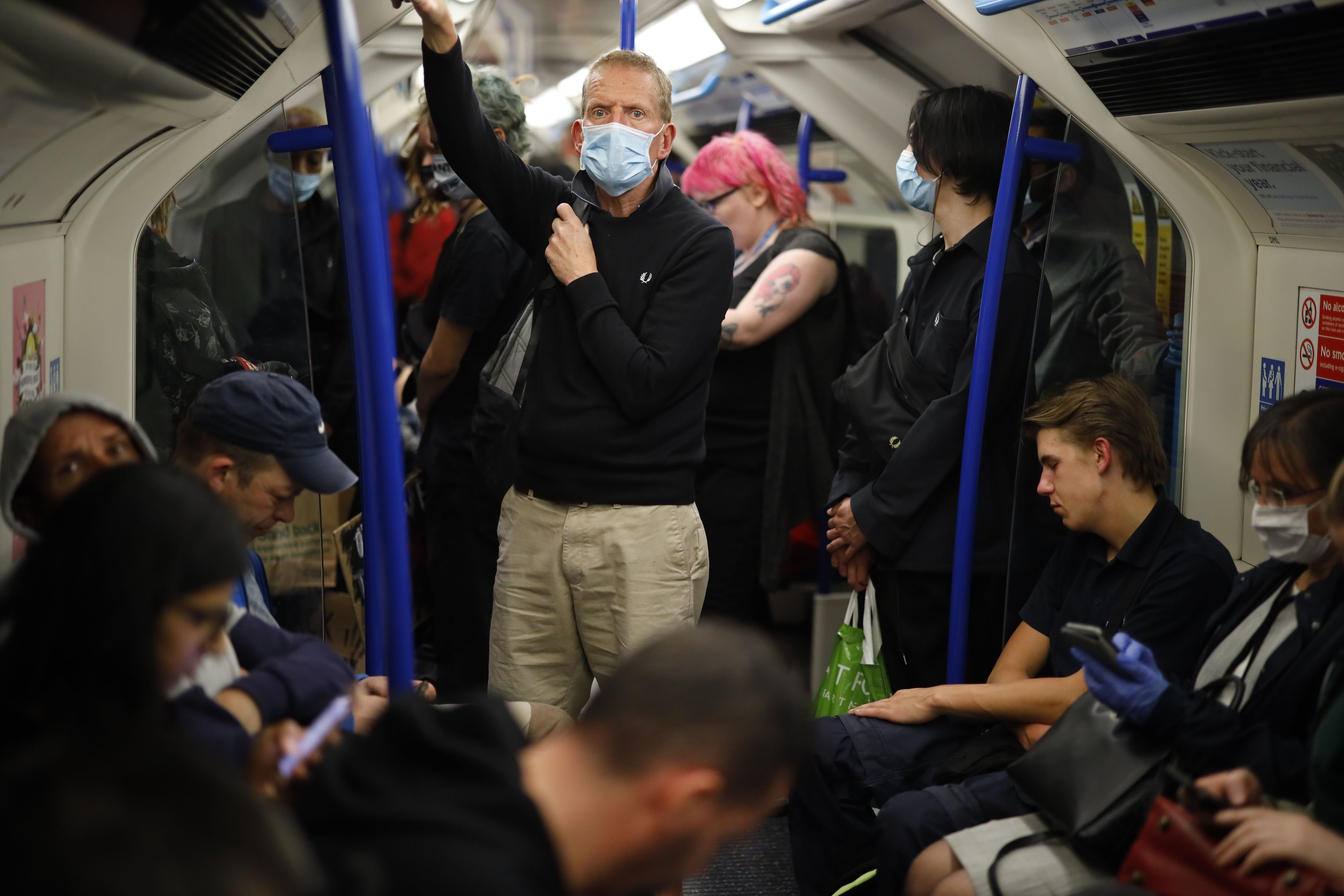 Commuters in masks on the London Underground