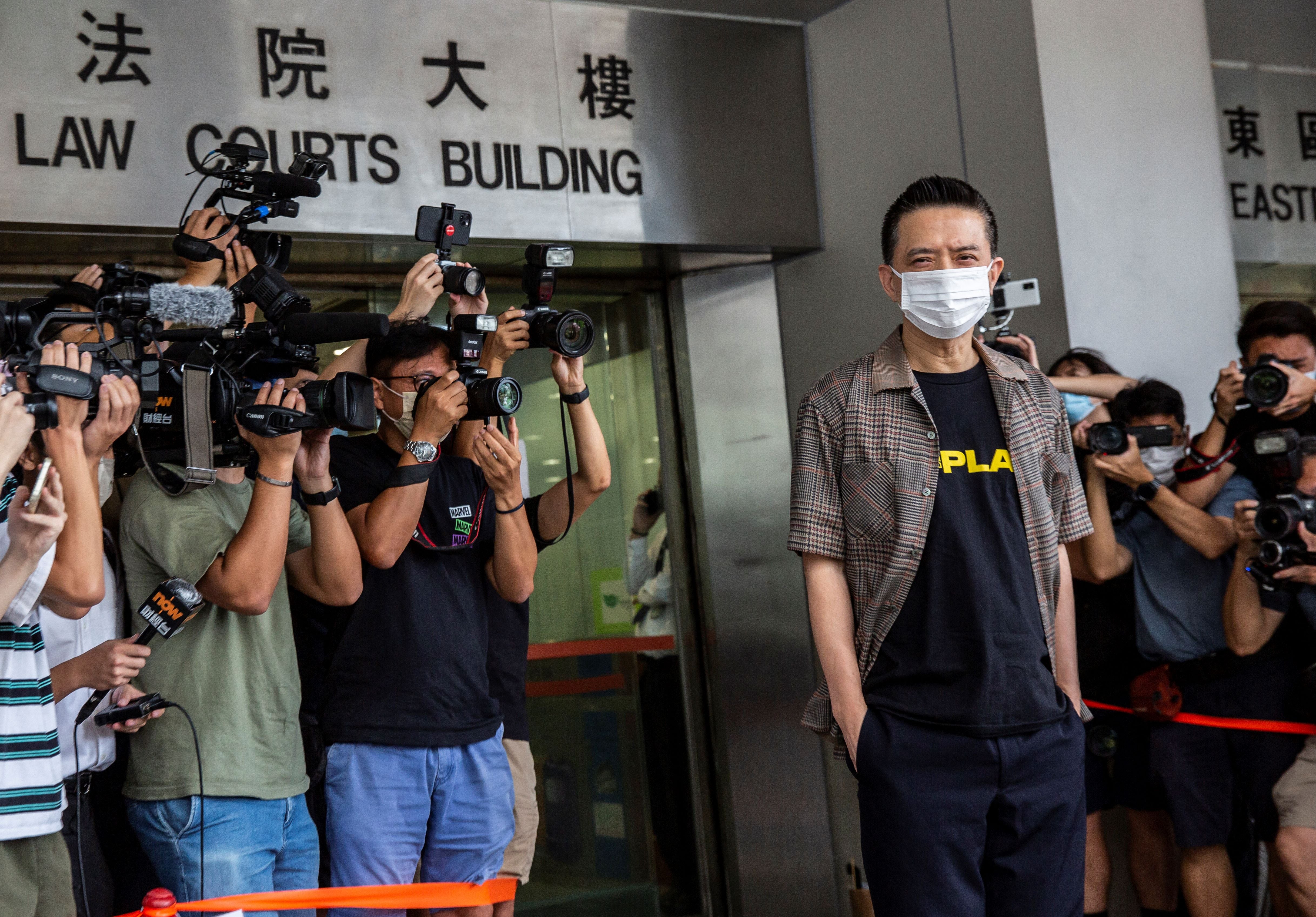 Hong Kong pro-democracy Cantopop singer Anthony Wong (R) arrives at the eastern district court in Hong Kong on Thursday