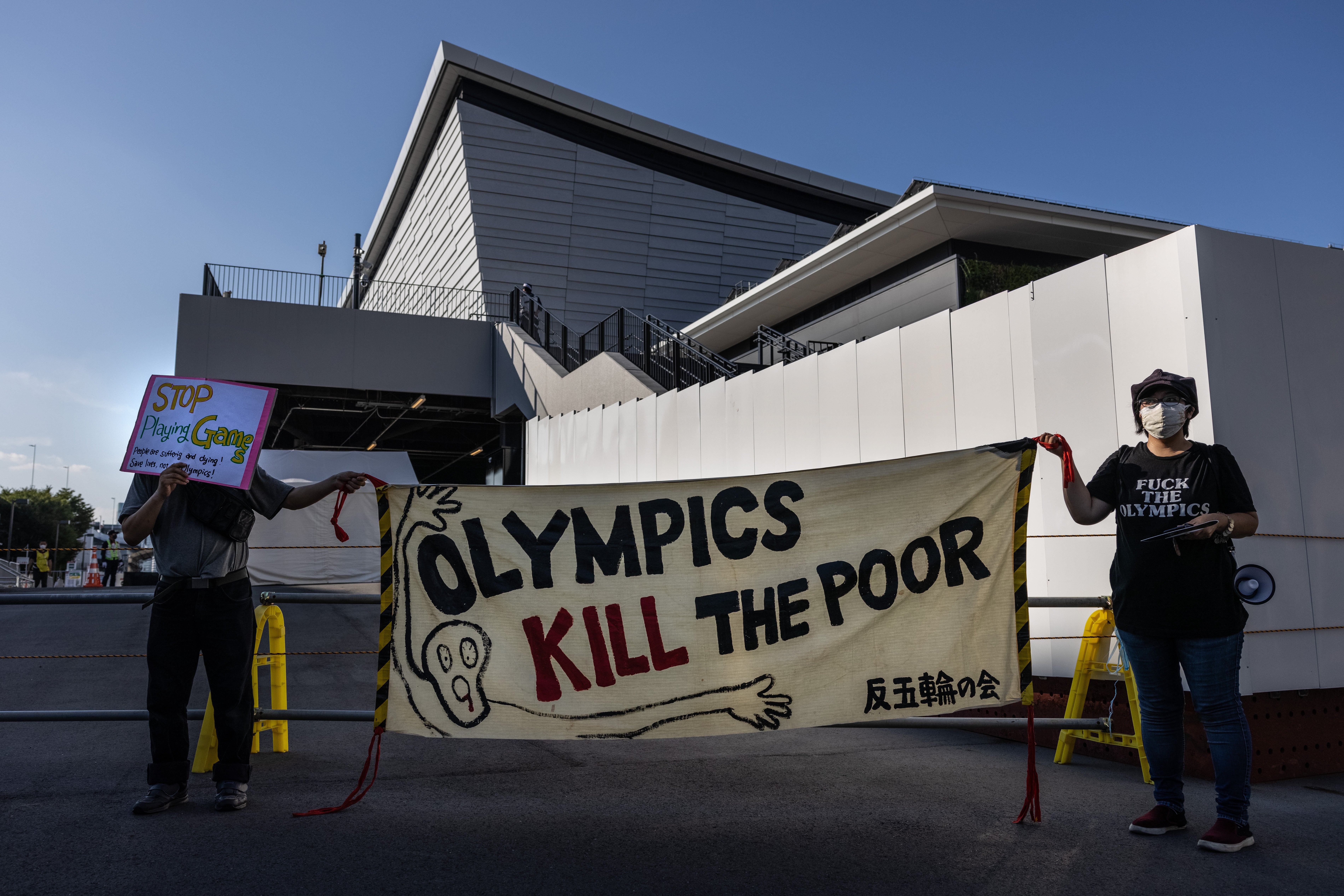 Japanese demonstrators hold a banner during an anti-Olympics protest outside Ariake Gymnastics Centre