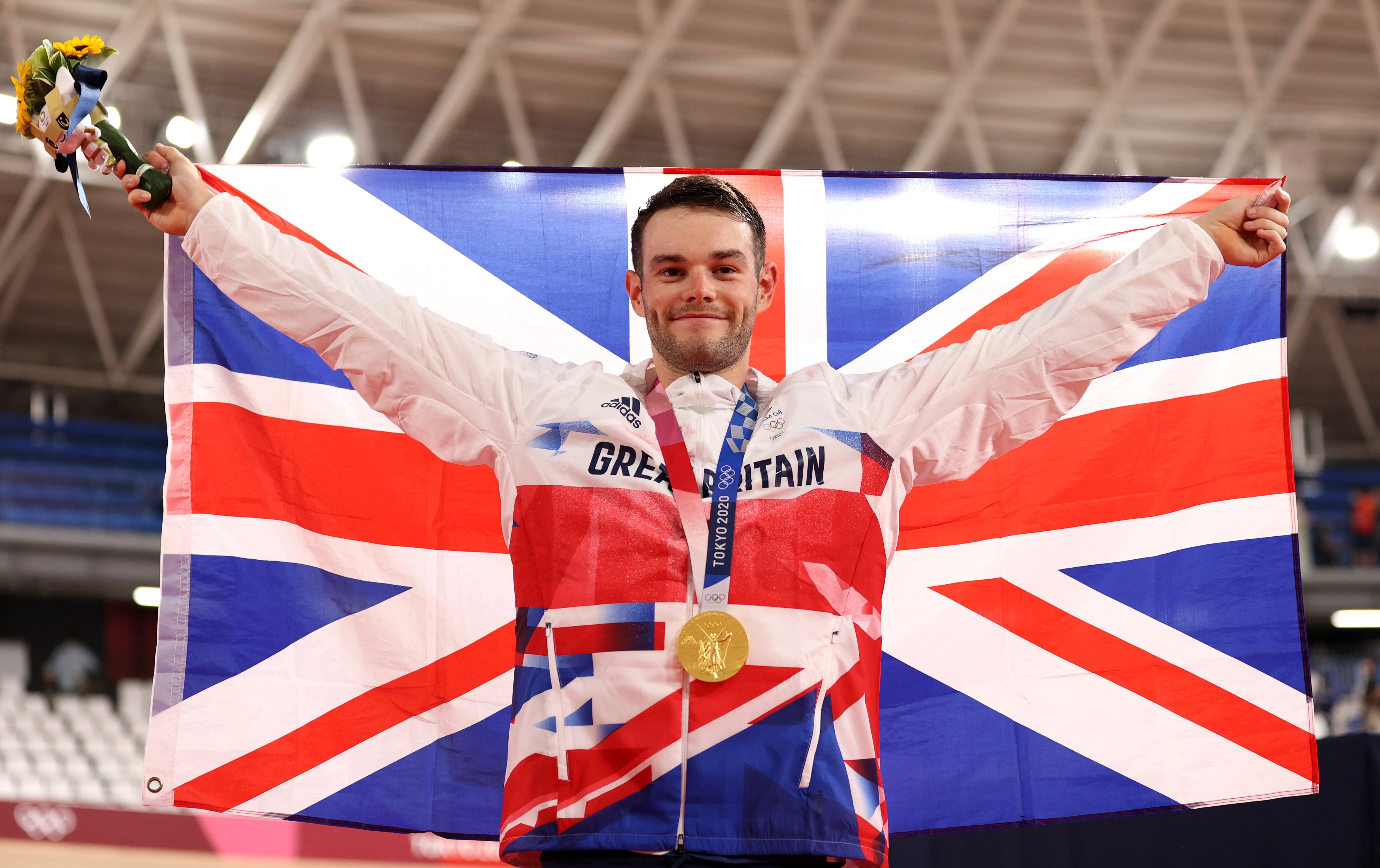 Gold medalist, Matthew Walls of Team Great Britain, poses while holding the Great Britain flag