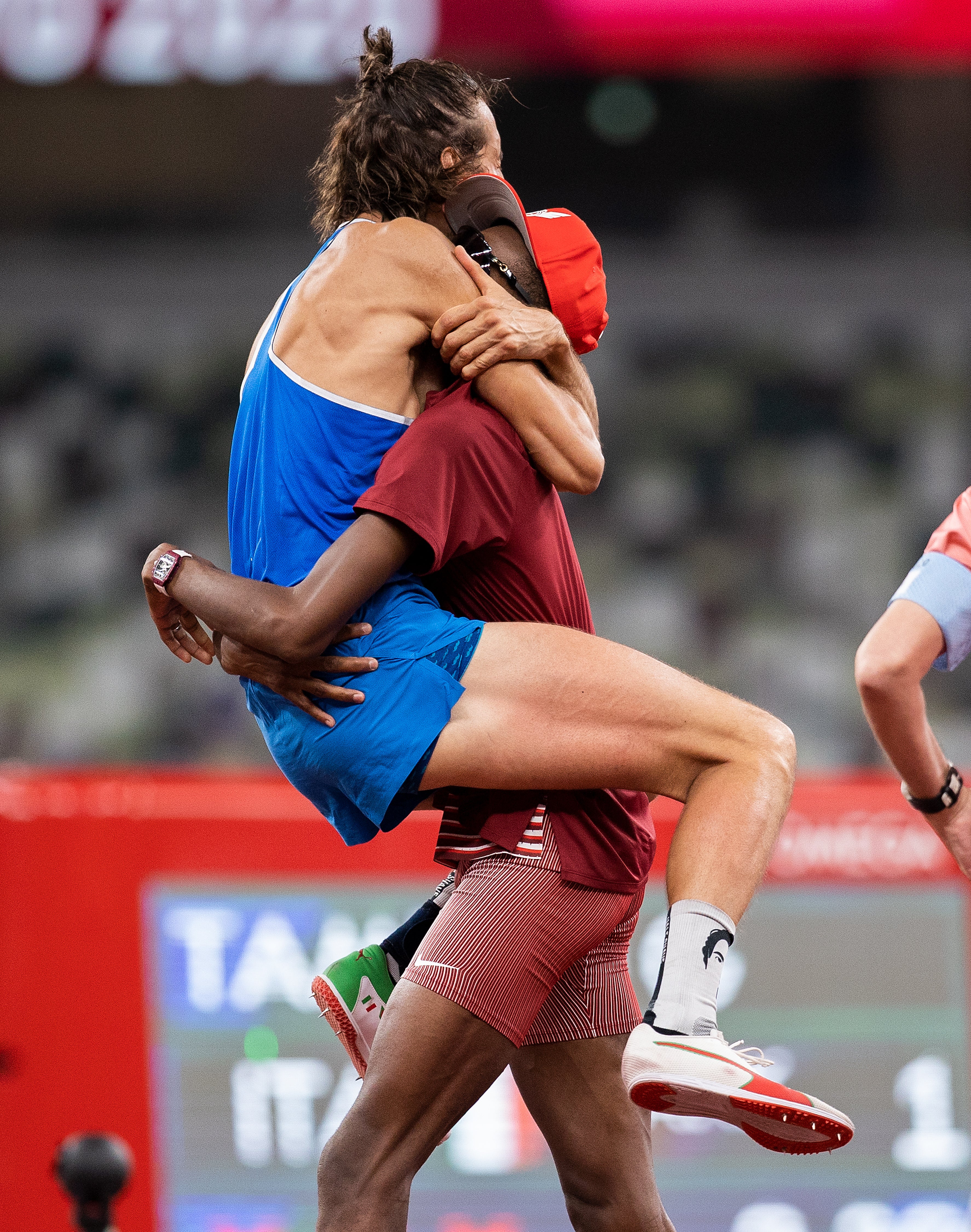 Gianmarco Tamberi and Mutaz Essa Barshim hug after winning gold