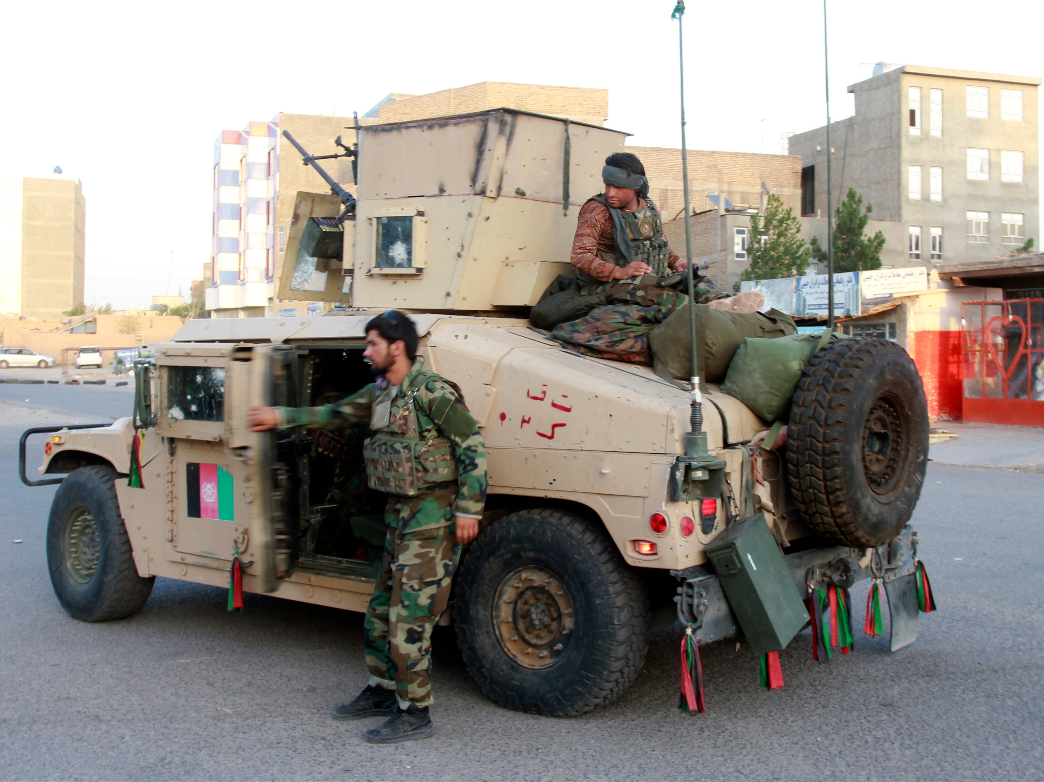 Afghan security personnel patrol in Herat