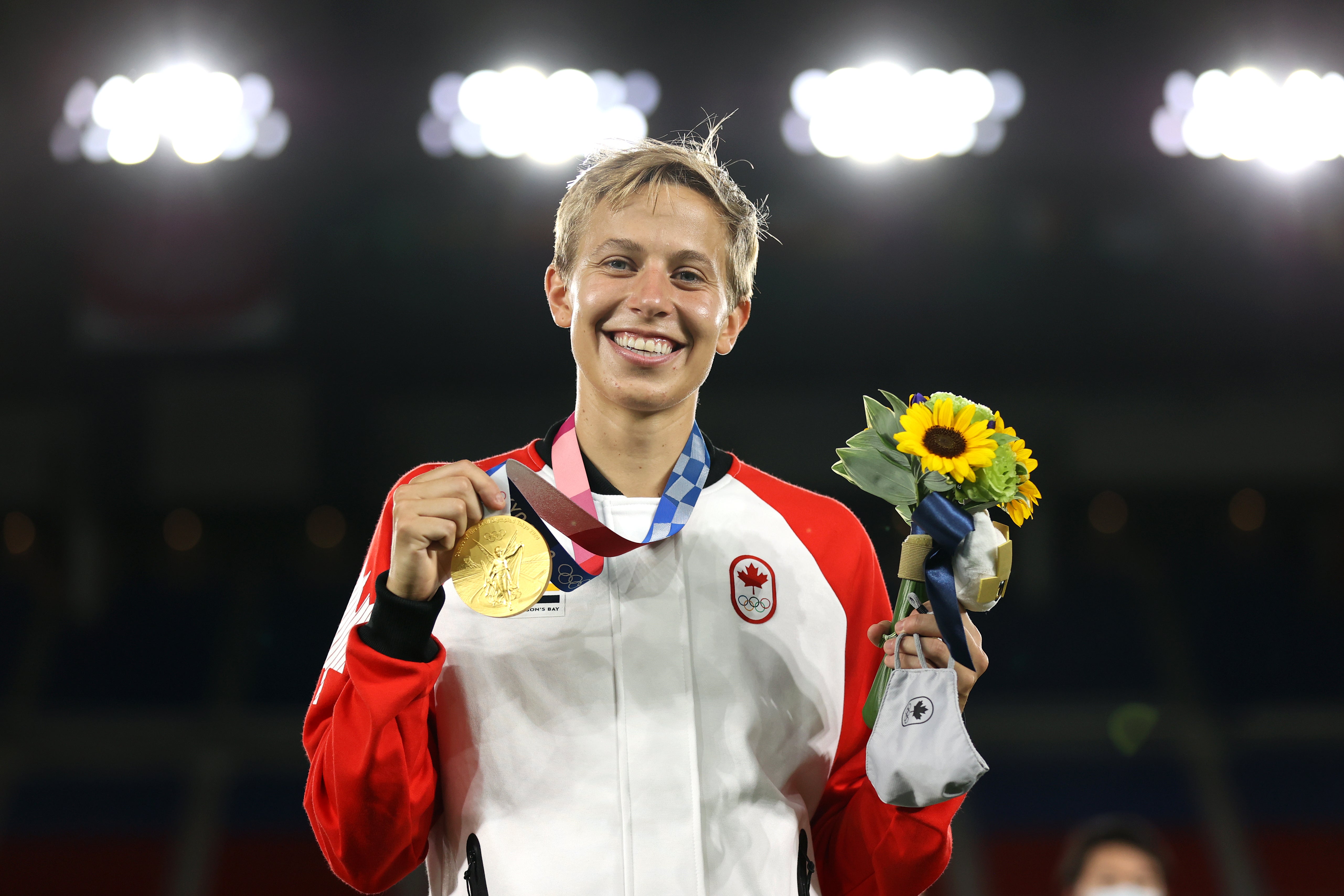 Gold medalist Quinn #5 of Team Canada poses with her gold medal during the Women's Football Competition Medal Ceremony on day fourteen of the Tokyo 2020 Olympic Games at International Stadium Yokohama on August 06, 2021 in Yokohama, Kanagawa, Japan