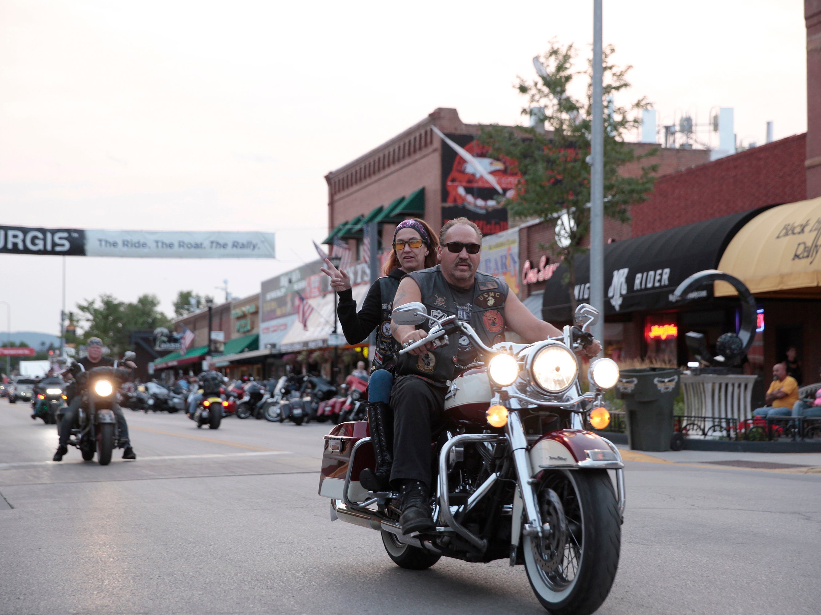 Motorcycles cruised through downtown Sturgis, S.D., on Thursday, Aug. 5, 2021. The Sturgis Motorcycle Rally starts Friday, even as coronavirus cases rise in South Dakota.