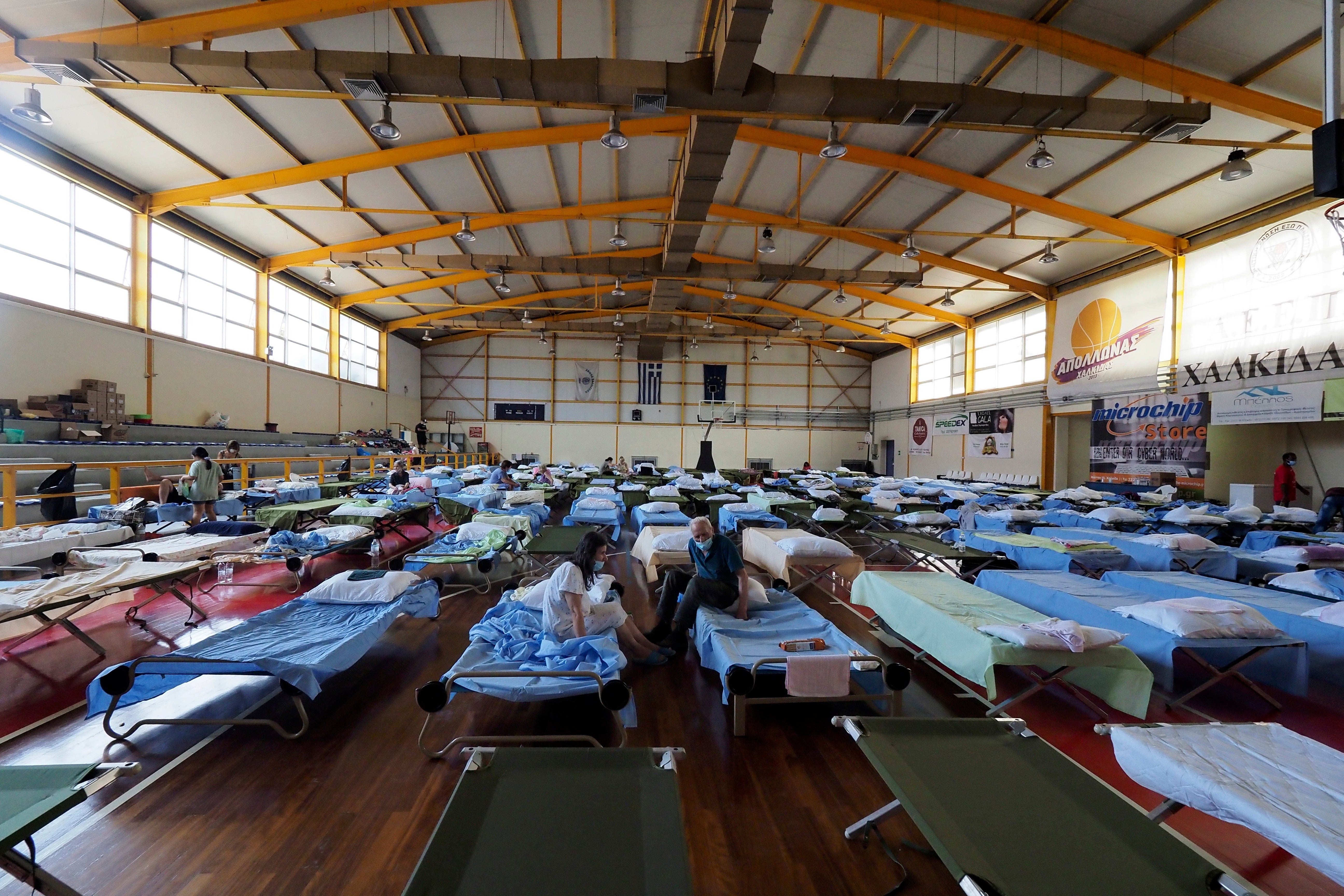 People who fled their homes during the wildfires are accommodated at an indoor hall in Chalkida the capital of Evia island, about 81 kilometres north of Athens.