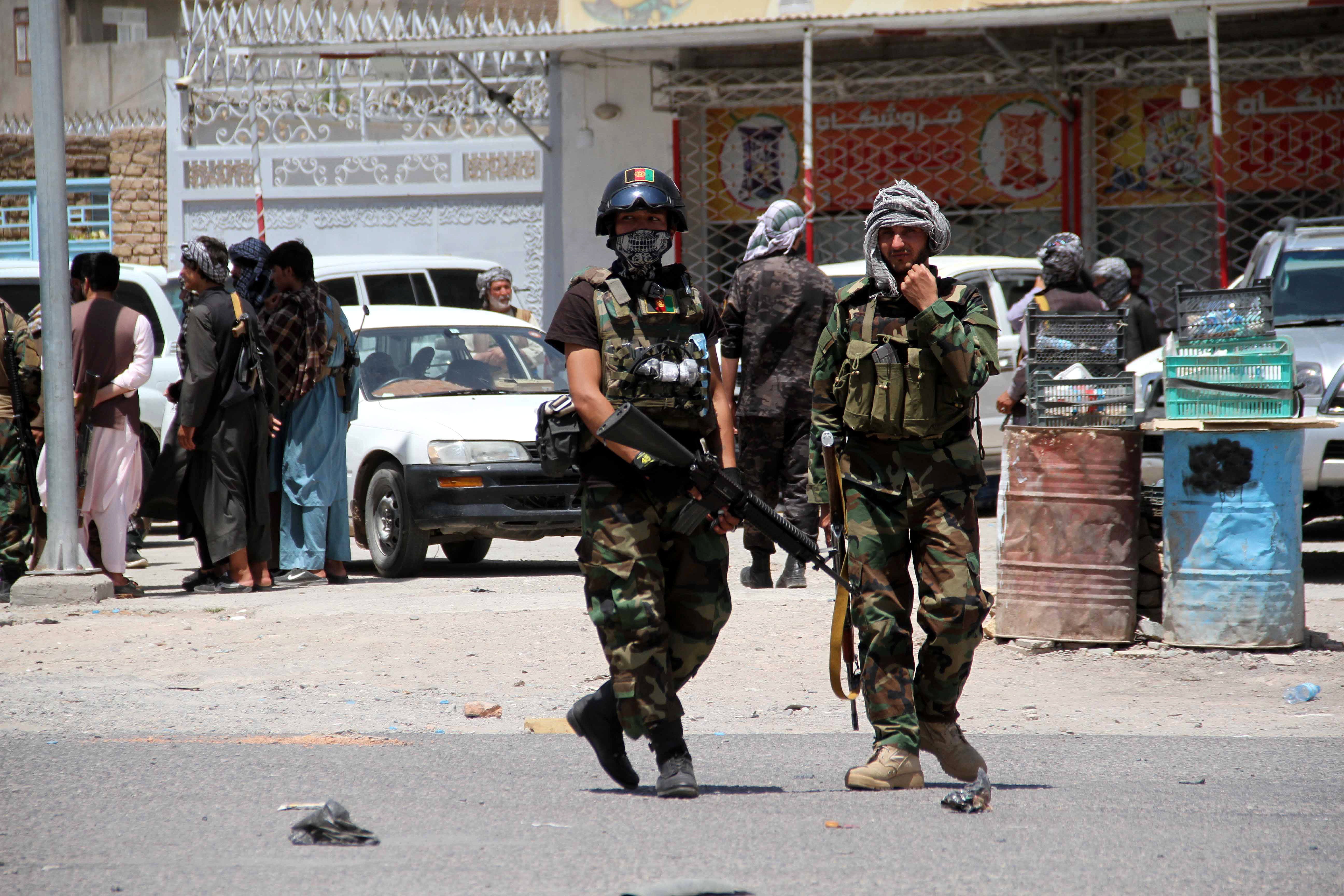 Afghan security officials patrol after they took back control of parts of Herat city following intense battle with Taliban militants on Friday