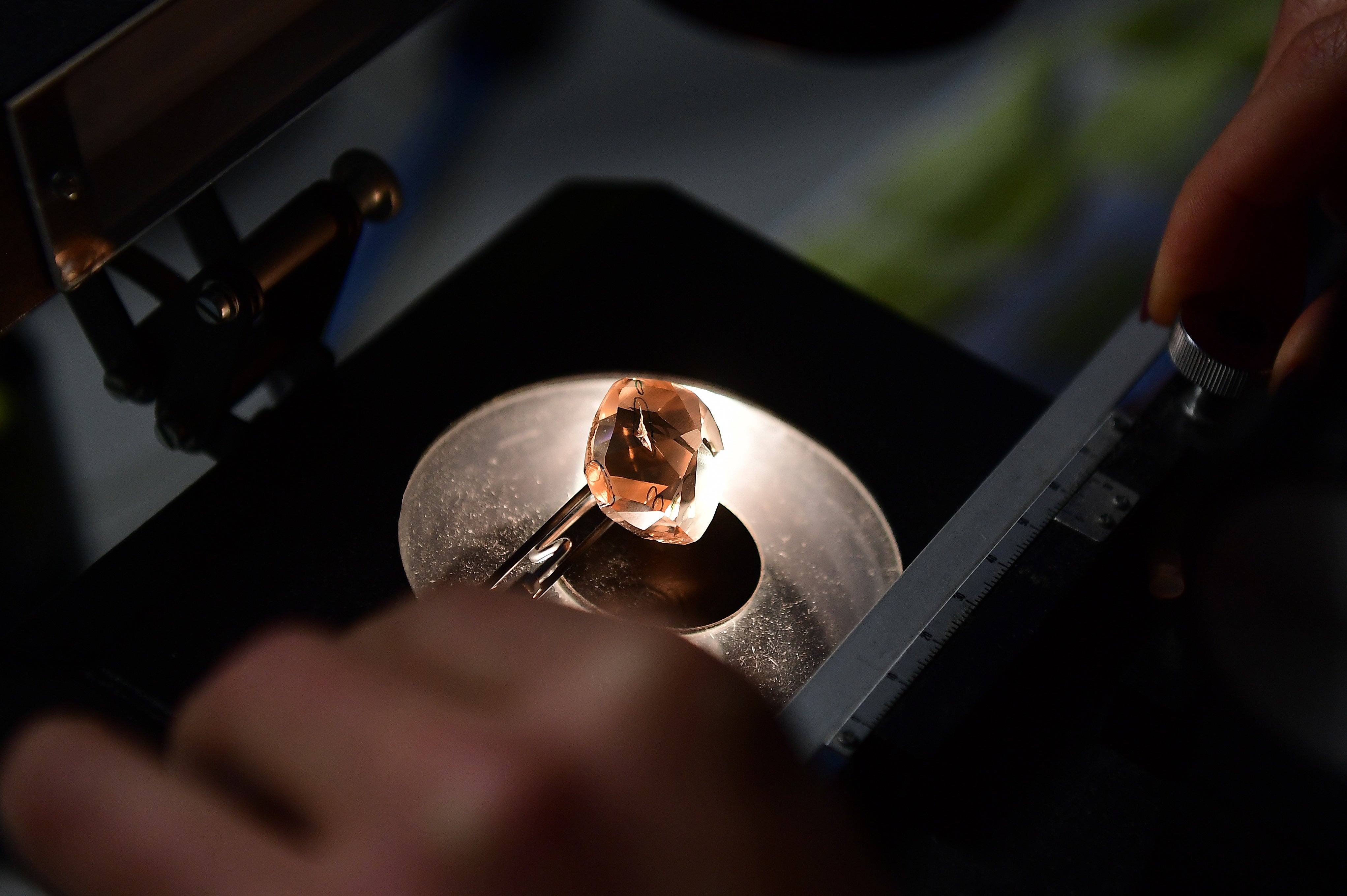 File: An expert studies a diamond under an electronic microscope