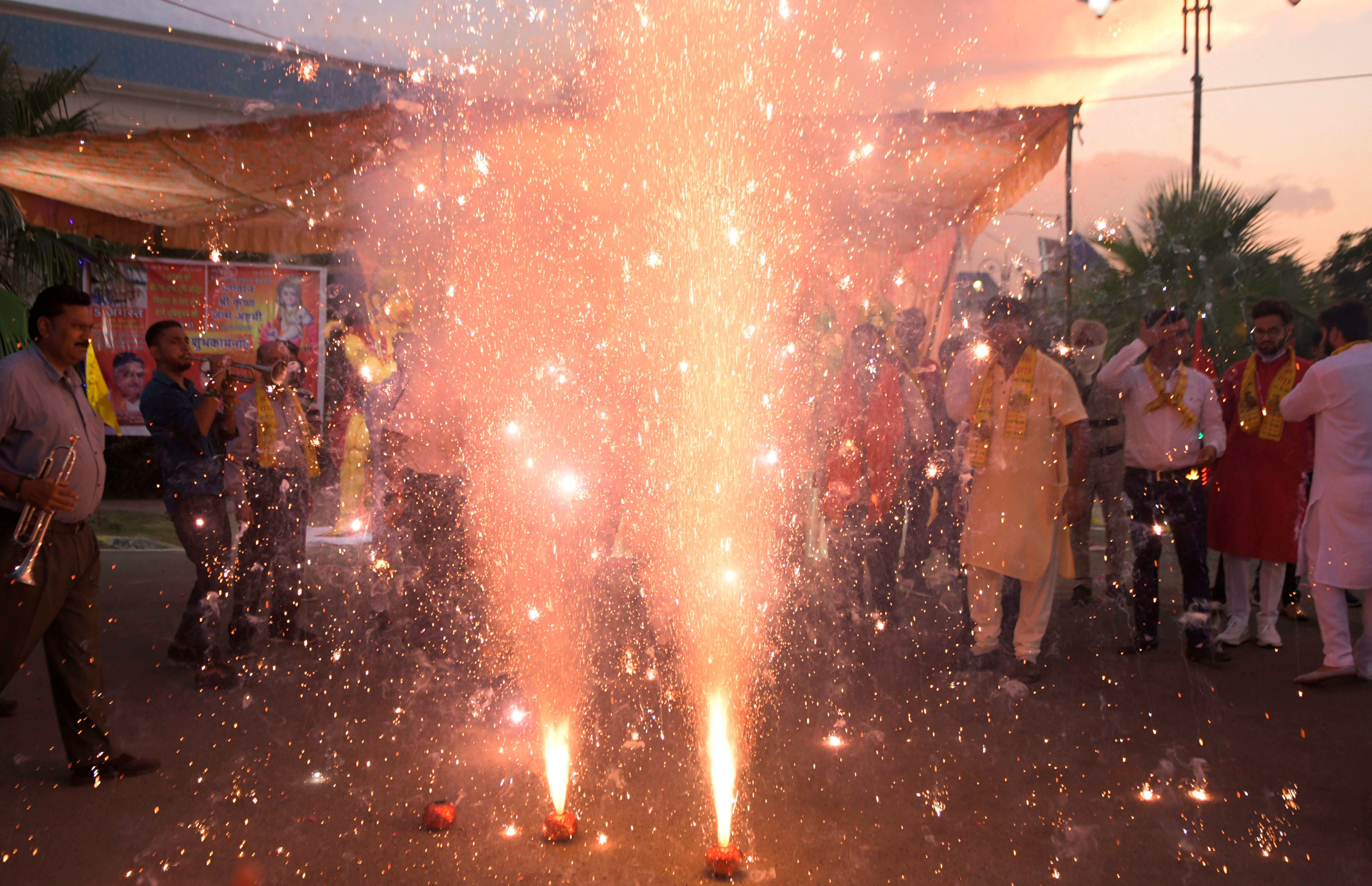 People watch a firecrackers display as they celebrate the groundbreaking ceremony of the Ram Temple in Ayodhaya, on the outskirts of Amritsar on August 5, 2020