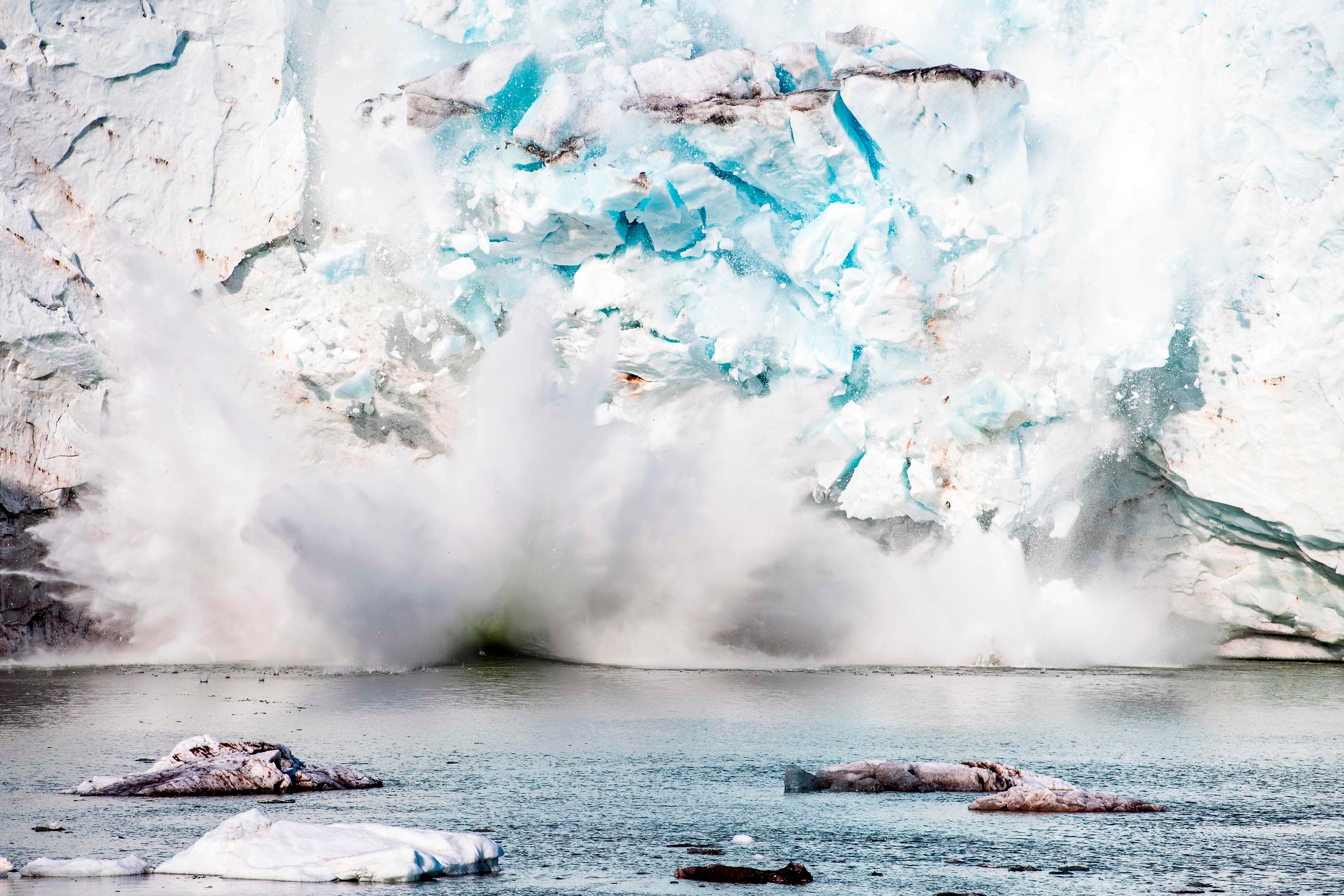 An iceberg calves off an ice shelf in Greenland in August 2019