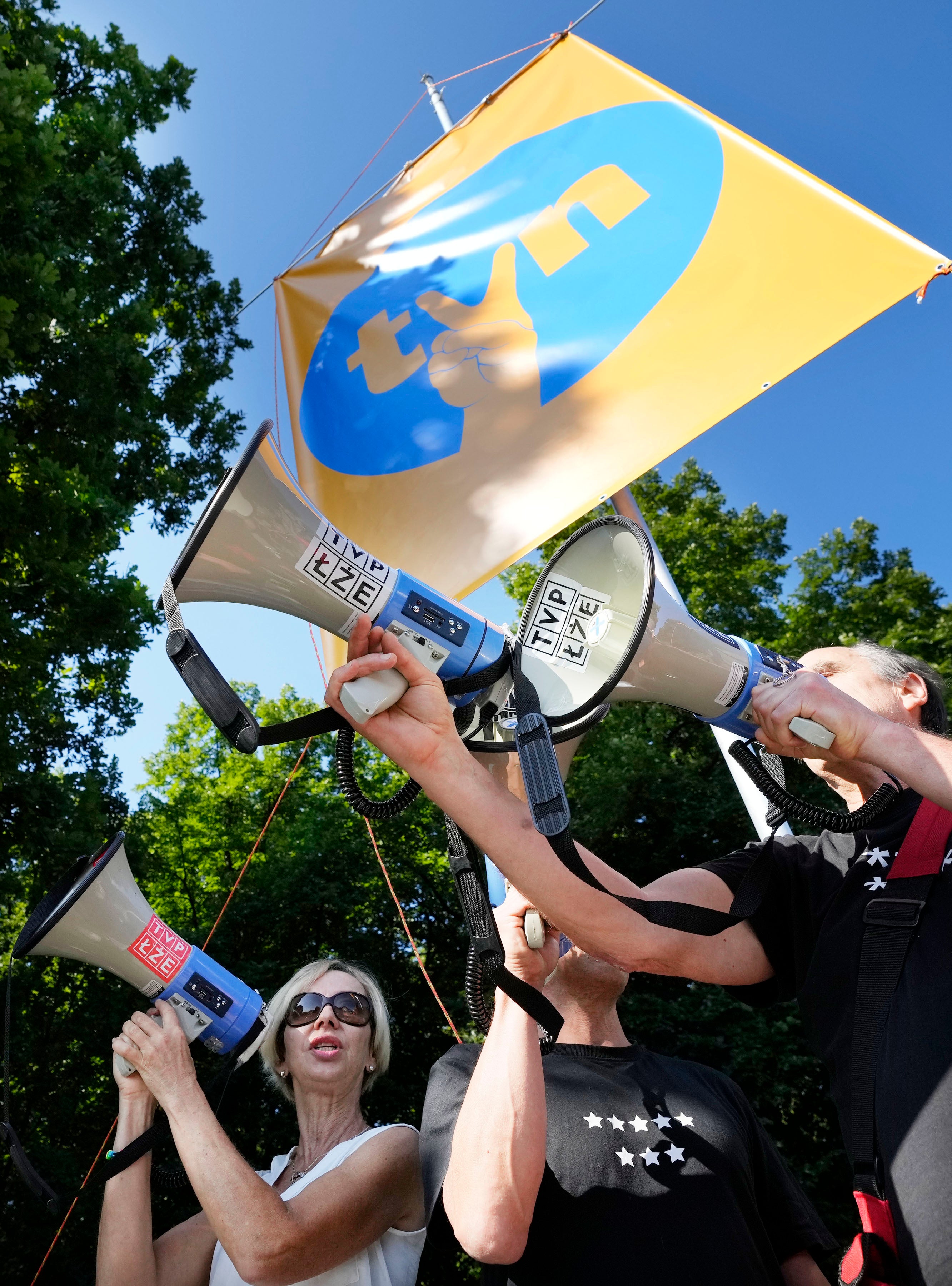 Protesters display posters in support of the independent broadcaster TVN during a demonstration in Warsaw