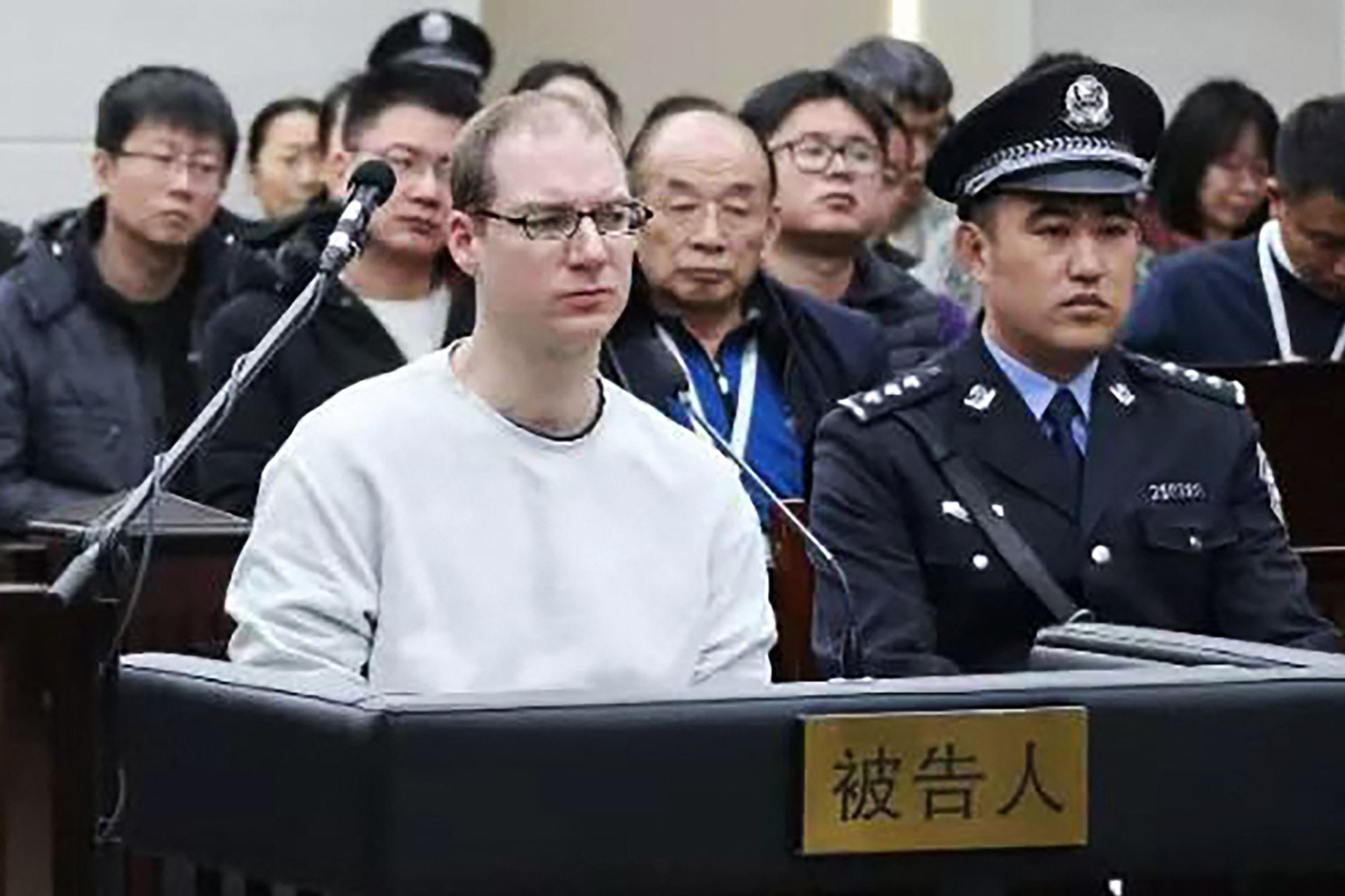 This handout photograph taken and released by the Intermediate Peoples' Court of Dalian on January 14, 2019 shows Canadian Robert Lloyd Schellenberg (front L) during his retrial on drug trafficking charges in the court in Dalian in China's northeast Liaoning province.