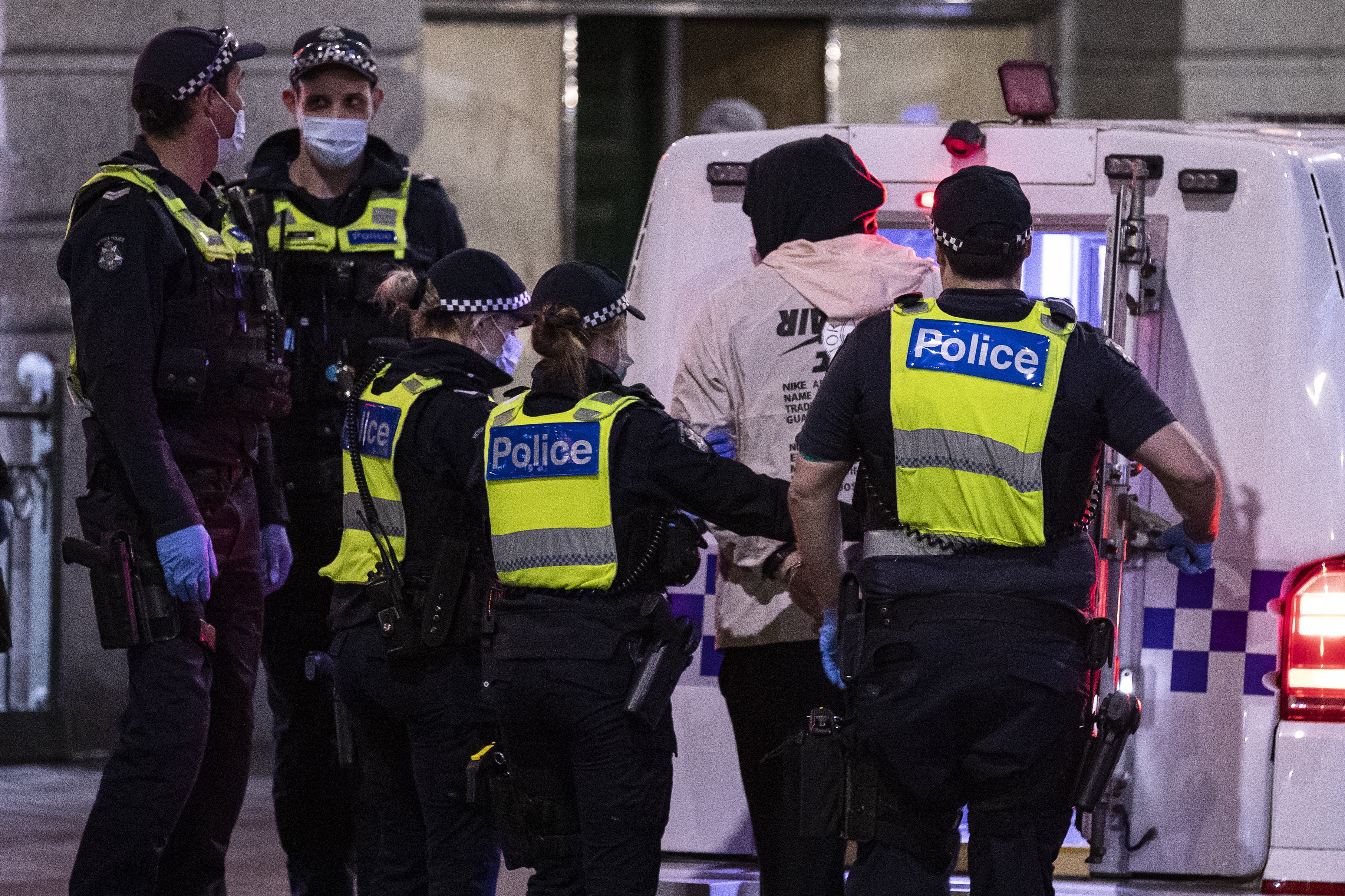 A man is arrested by police during a proposed anti-lockdown protest in Melbourne, Australia