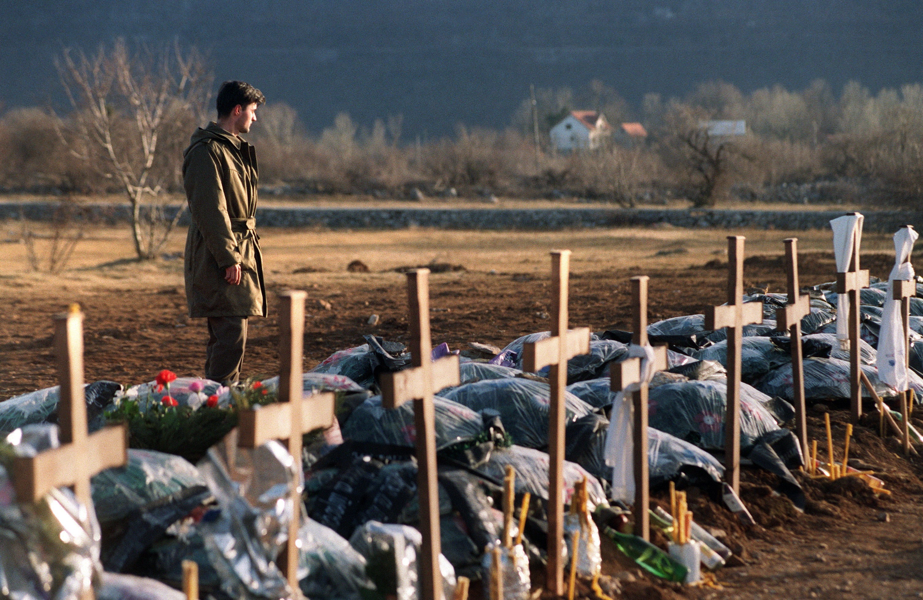 A soldier stands by Serbian graves near Gracac, 6 February 1993. His fellow soldiers were killed in a Croatian ambush a fortnight earlier, 60km from Knin, the Serbian enclave of Krajina