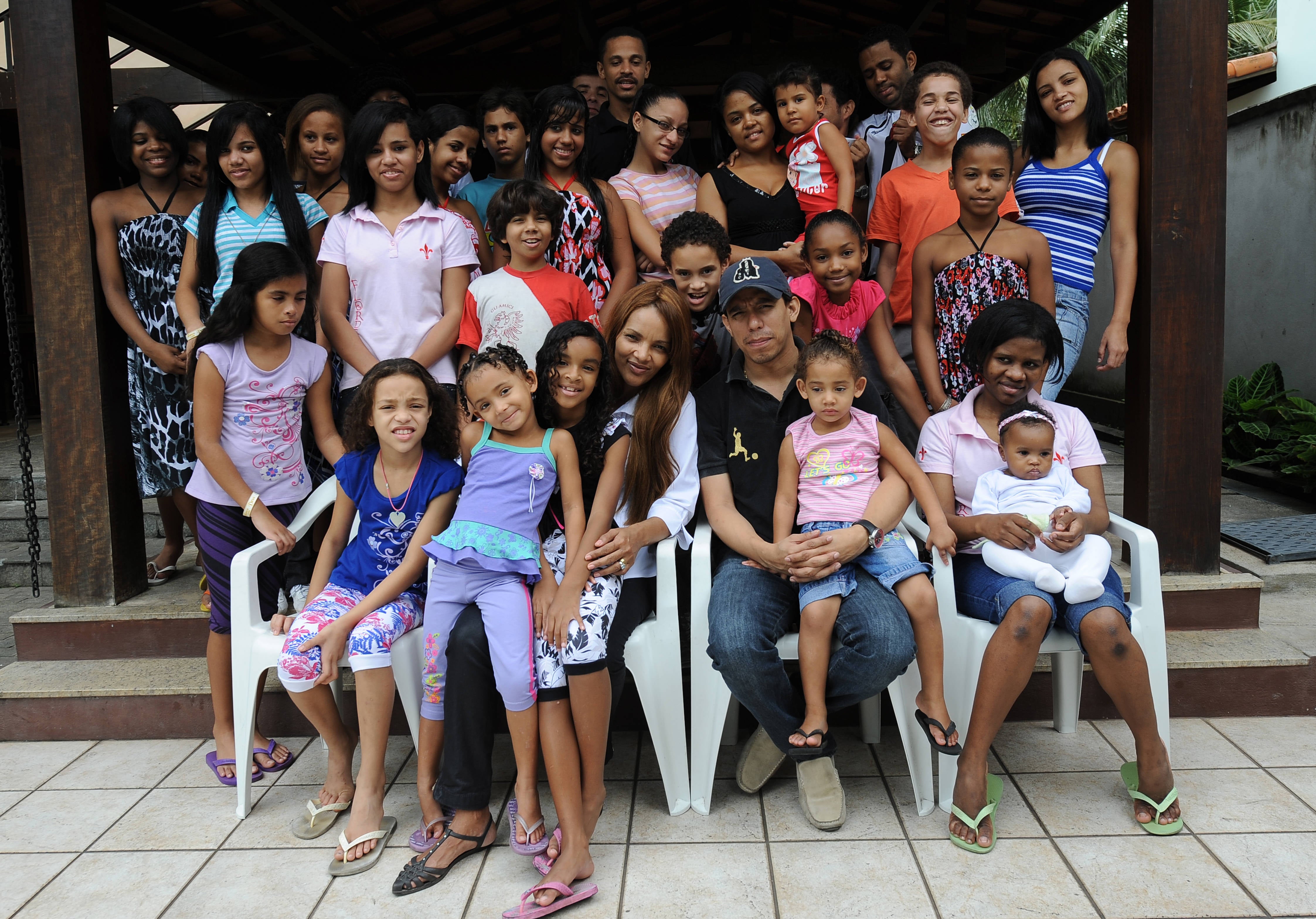 FILE. Brazilian Flordelis dos Santos (C) poses with some of her 50 sons --four of them her own and another 46 adopted-- at their home in Niteroi, on the other side of the Bay of Rio de Janeiro, Brazil, 21 October, 2009. - She has been expelled from Brazil congress over her alleged role in her husband’s murder.