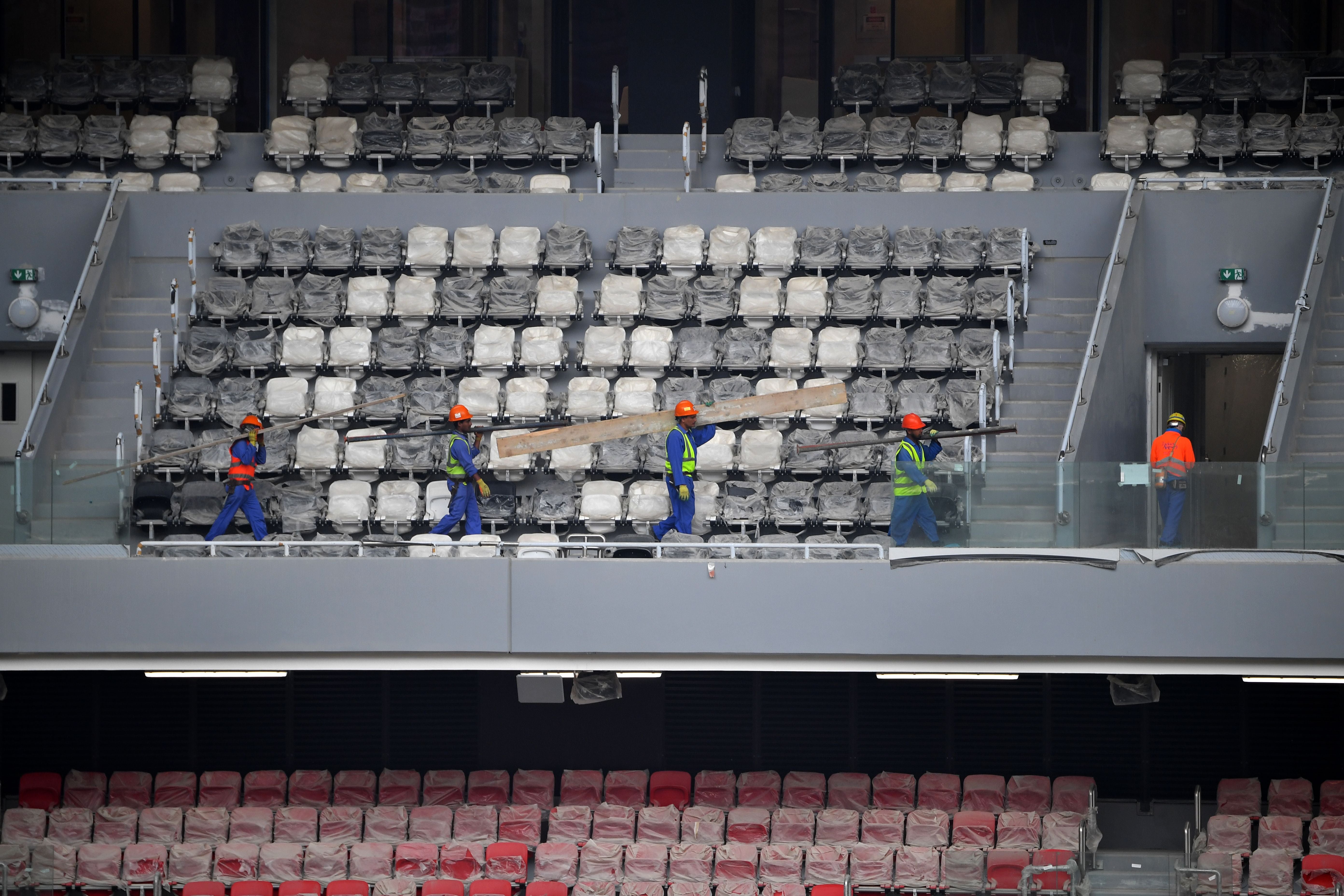 Construction workers at Qatar’s new al-Bayt Stadium in Doha