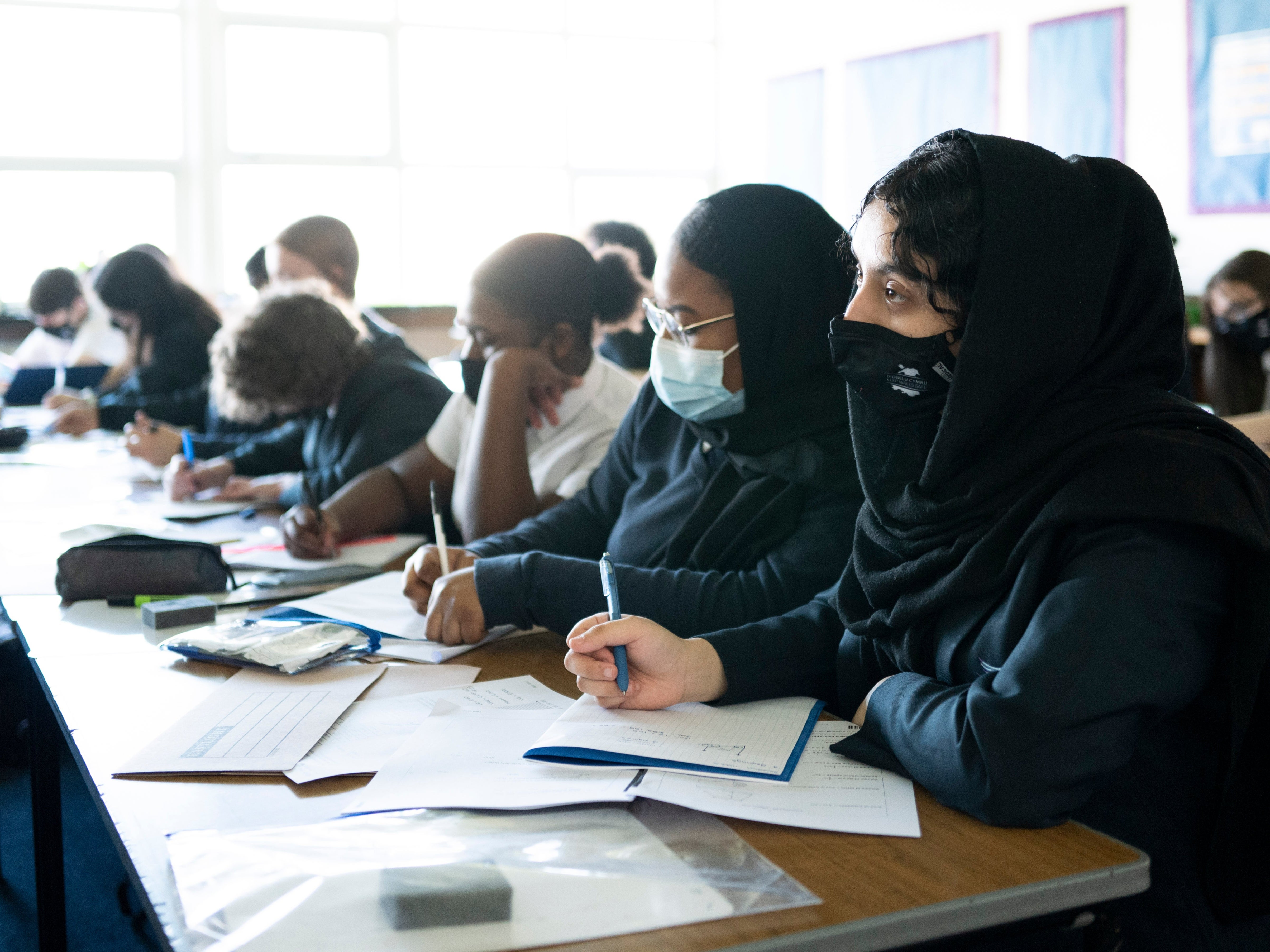 Schoolchildren look on during a lesson at Willows High School in Cardiff