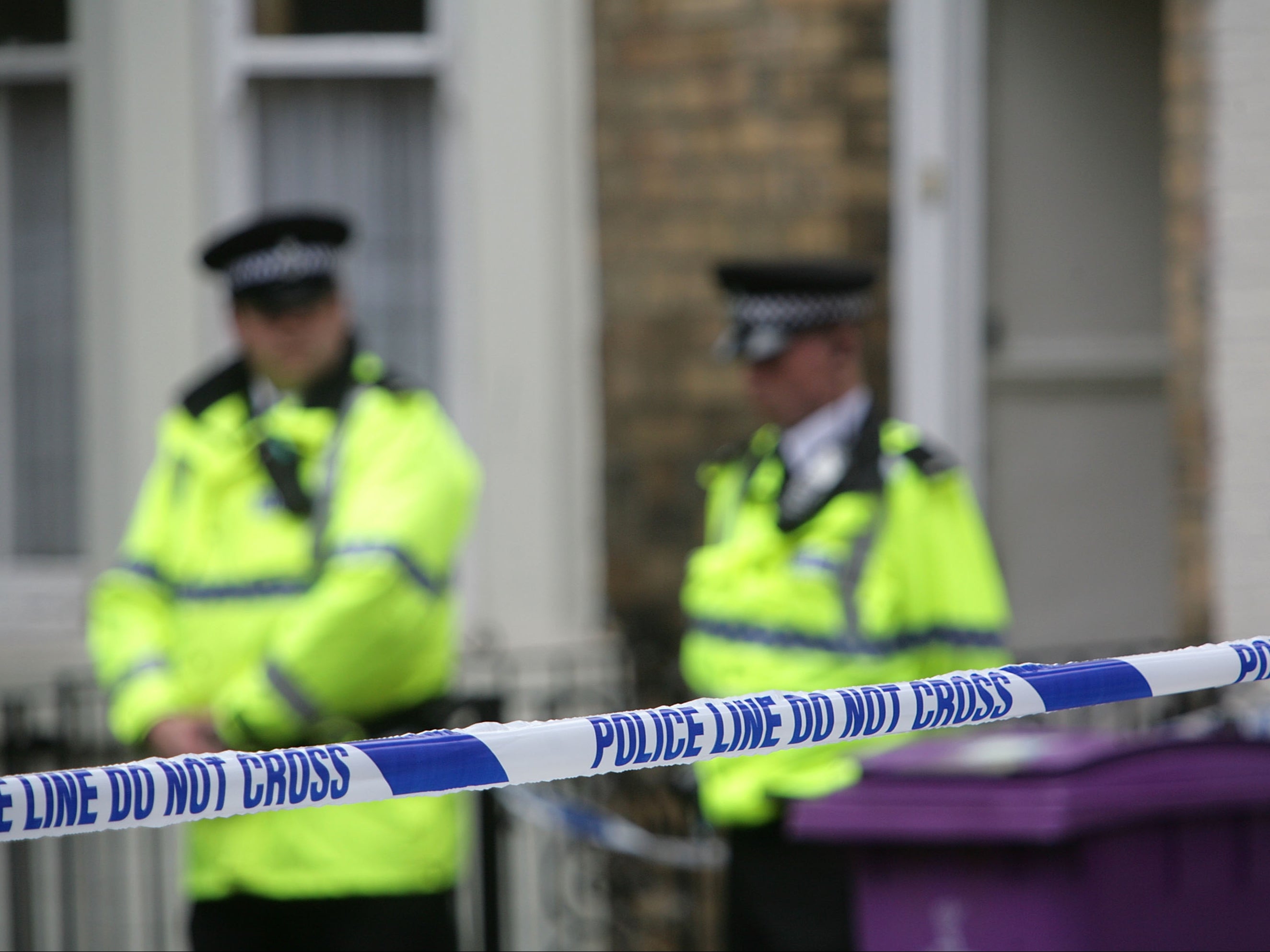 Police officers stand outside a house in Hatherley Street, Liverpool after a raid searching for terror suspects in July 2007