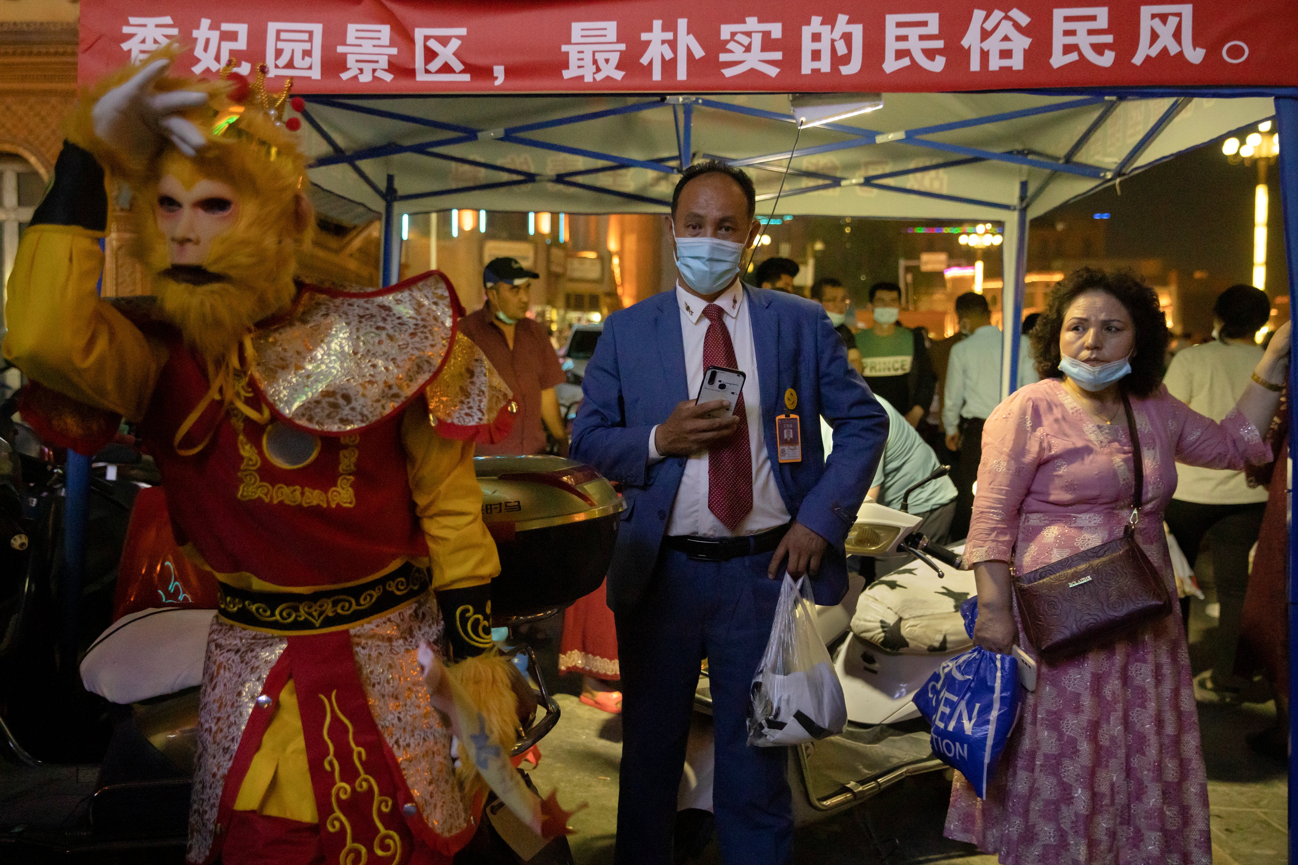 A performer in a monkey costume at a night market in the old city in Kashgar during the May holidays