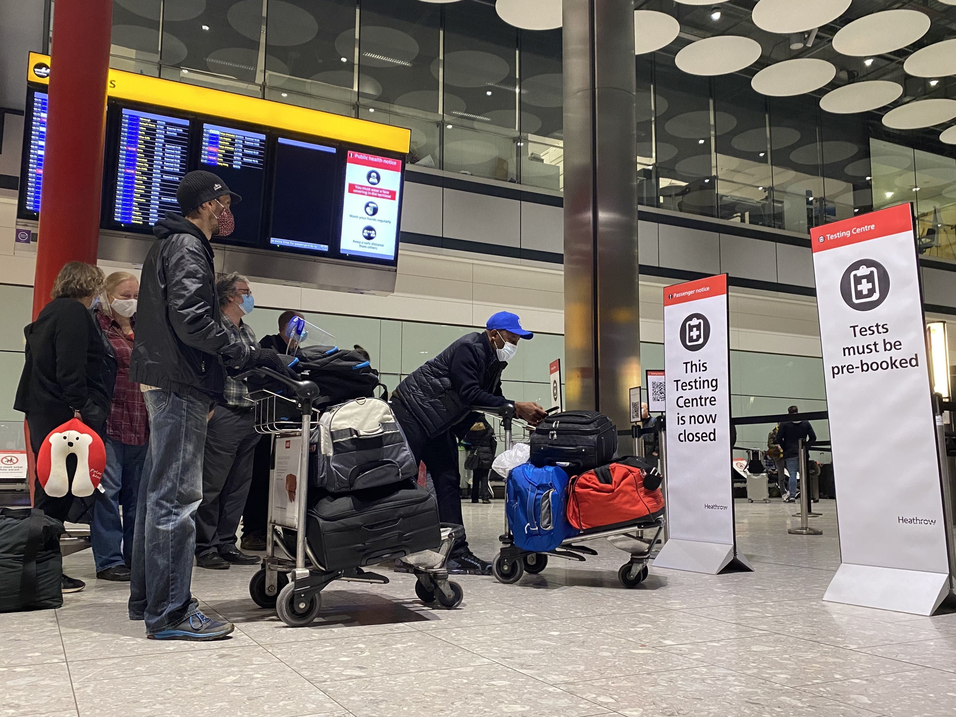 This file photo from 18 August shows passengers waiting in line outside the testing centre in London Heathrow Airport’s Terminal 5