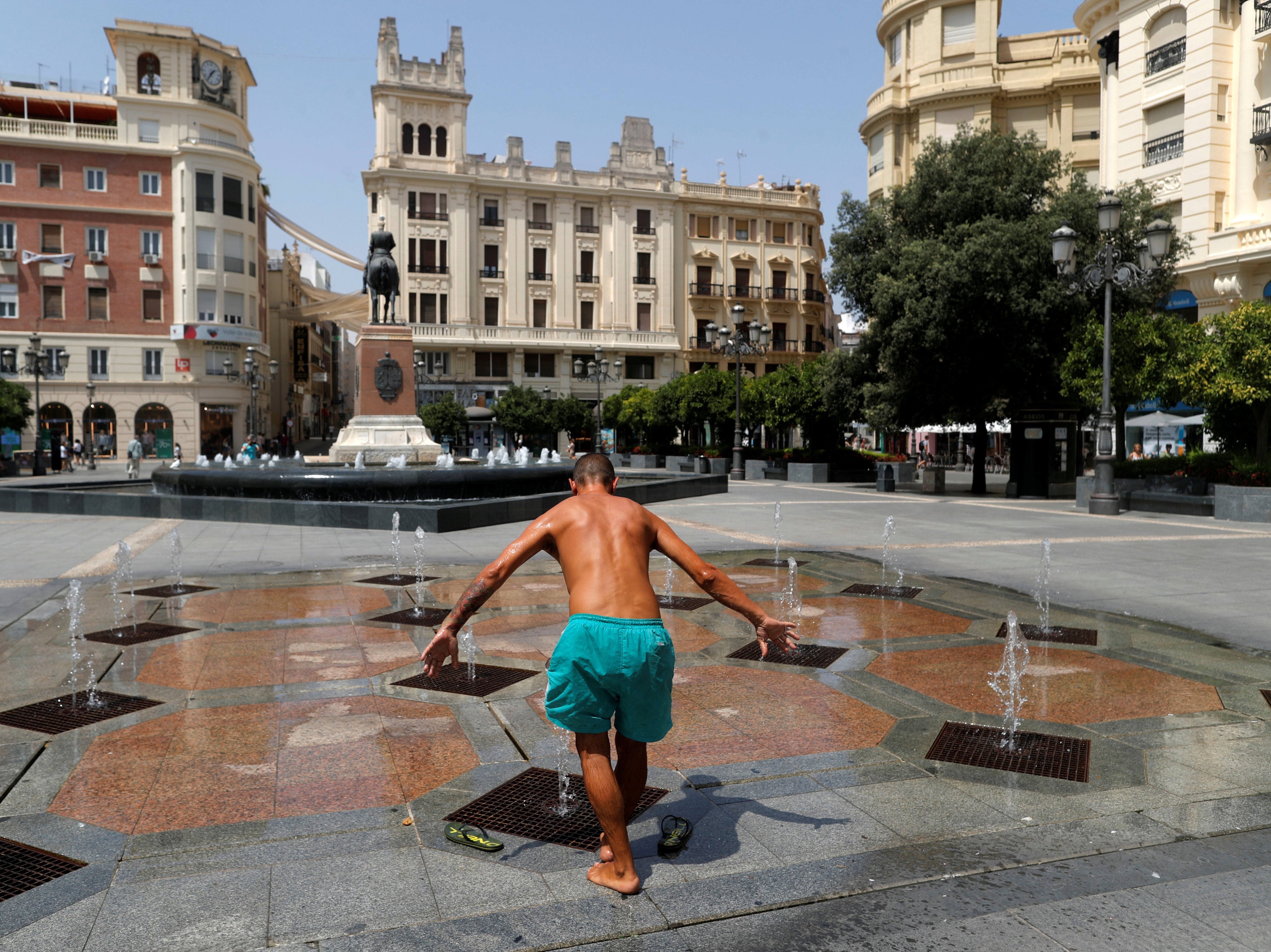 Ivan Hristov Nenov, 46, cools off in a fountain at the Las Tendillas square, as a heatwave hits Spain, in Cordoba, southern Spain