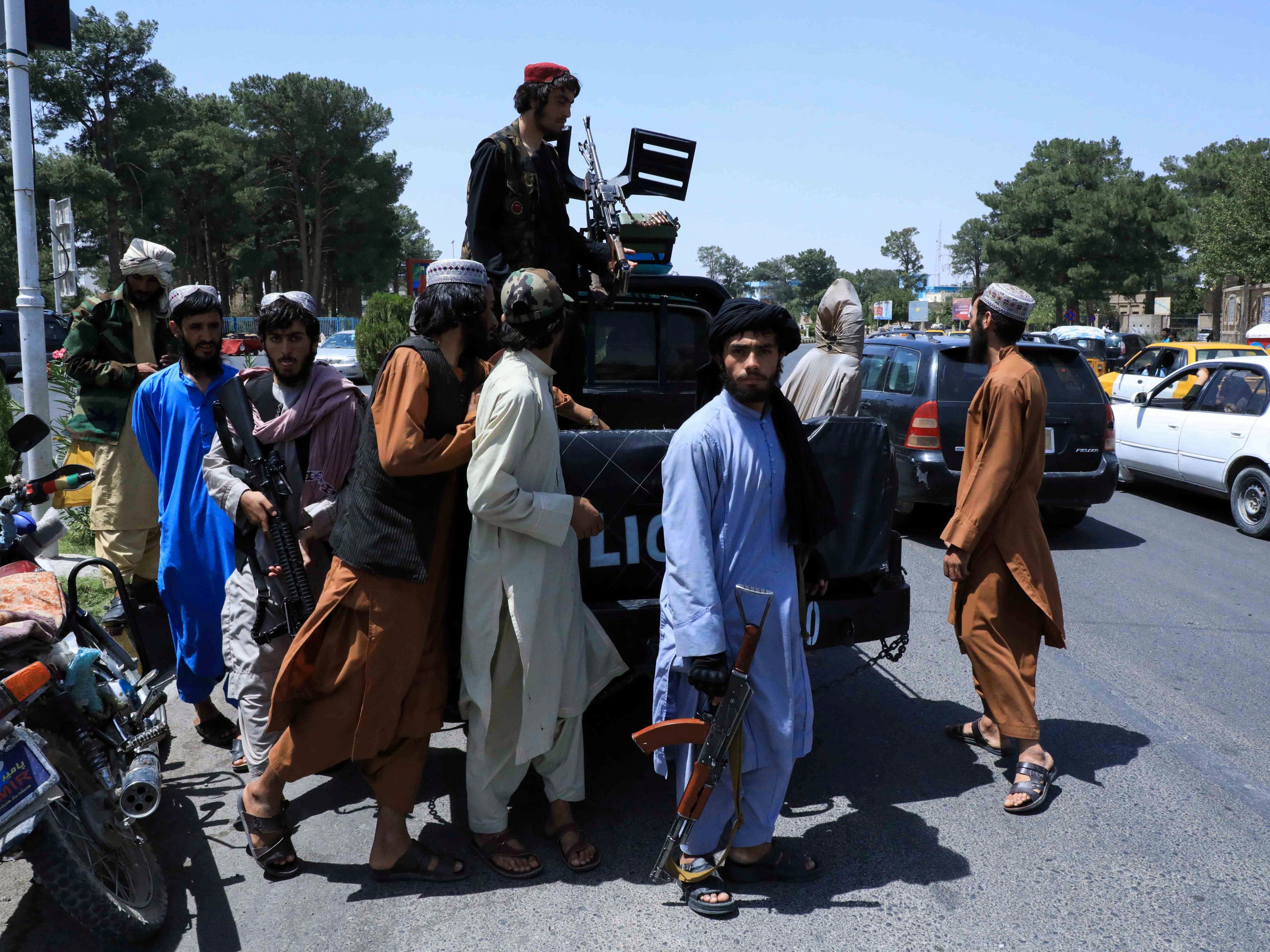 Taliban forces patrol a street in Herat, Afghanistan