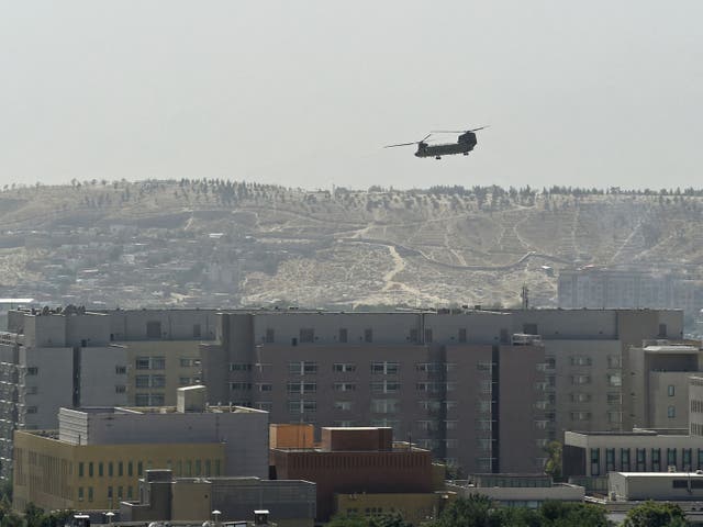 <p>A US military helicopter is pictured flying above the US embassy in Kabul </p>