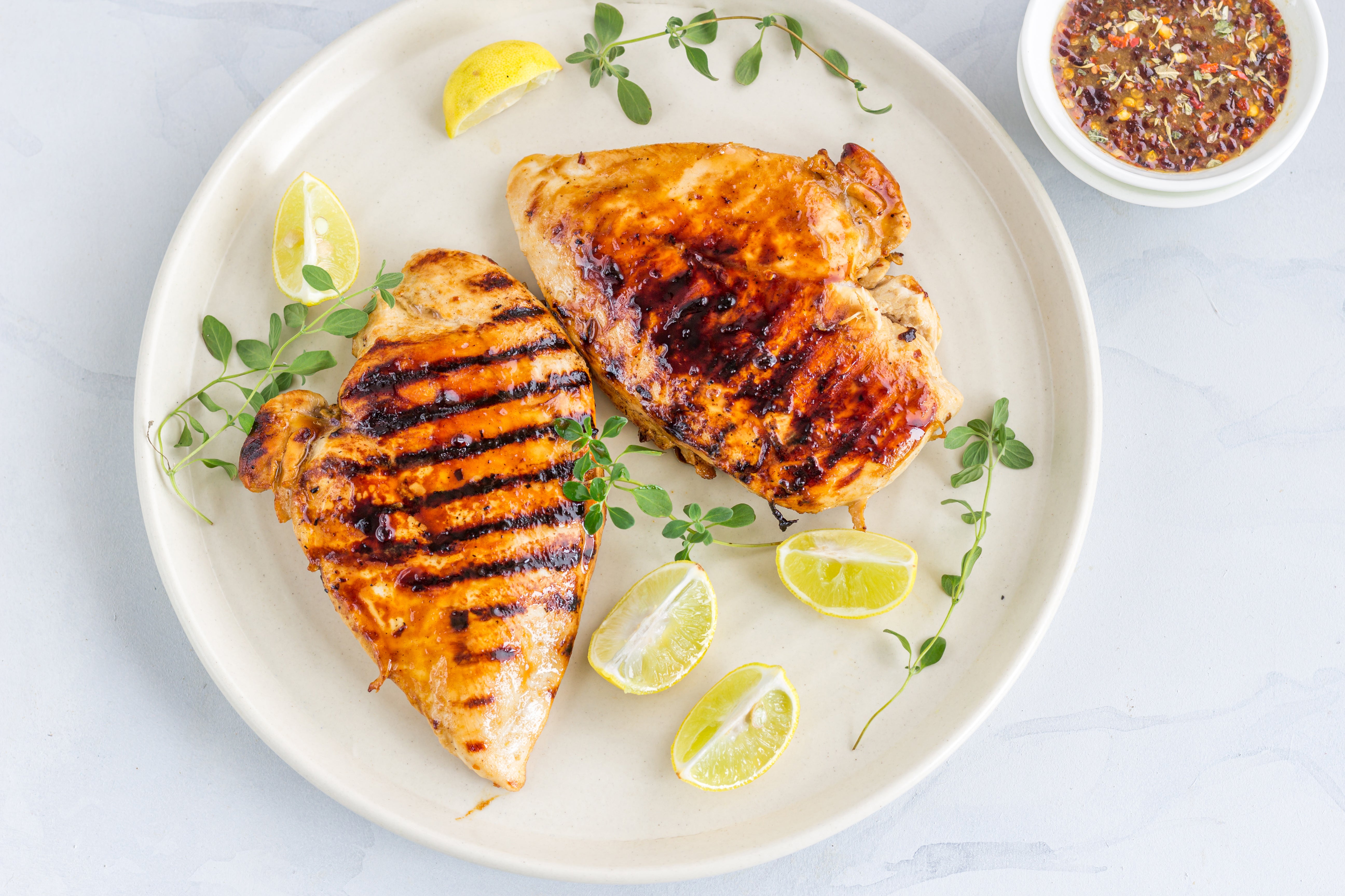 Cooking these classic herb and lemon chicken breasts over charcoal gives them the deepest, smokiest taste