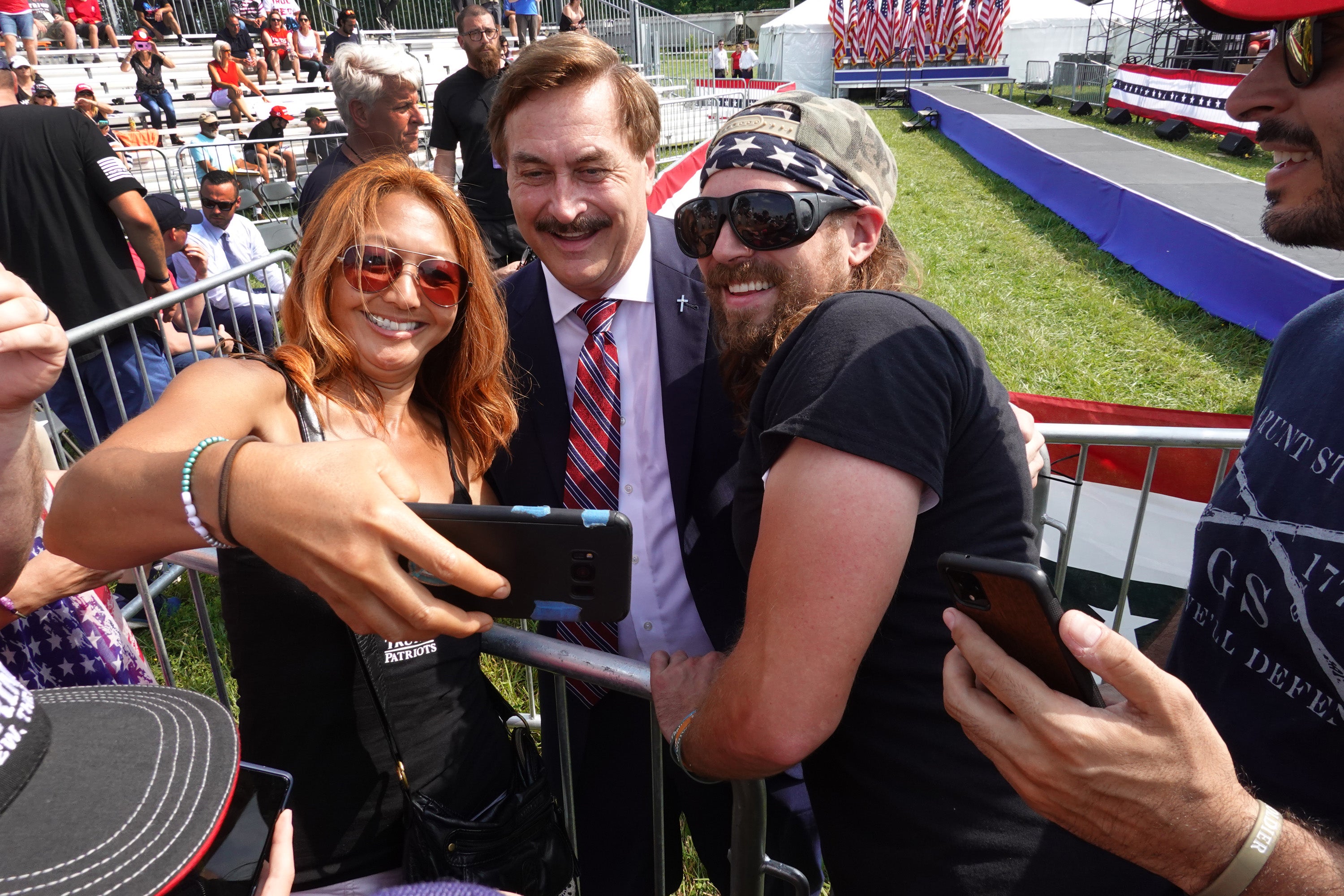 Mike Lindell poses for a selfie with Trump supporters at a rally in Ohio in June