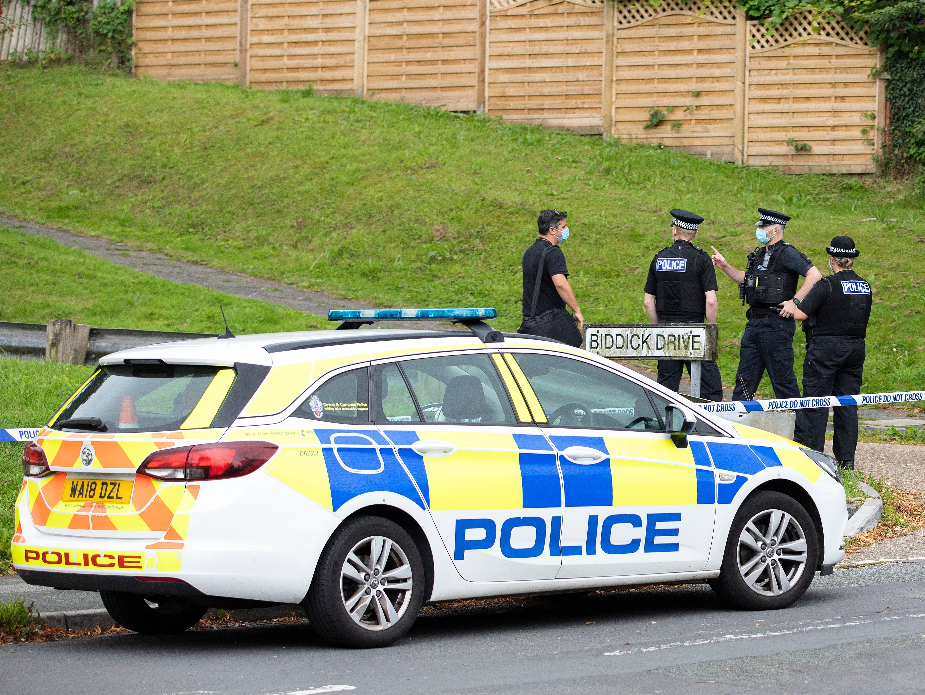 Police teams work near the scene on Biddick Drive following the shootings