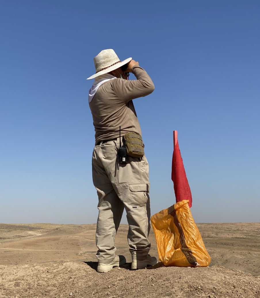 A MAG operative acts as lookout to make sure the area is clear before the cache of explosives is destroyed