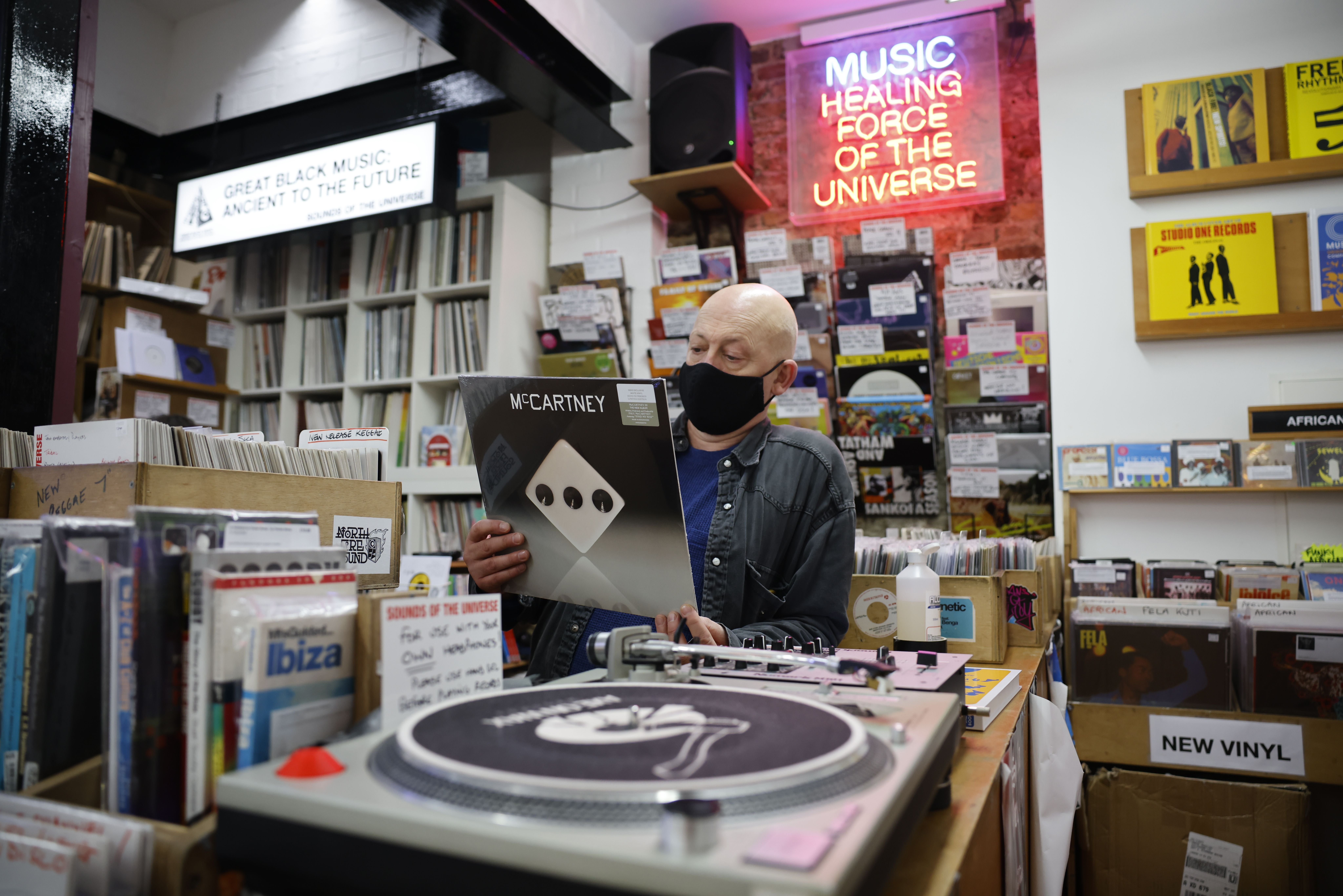 Karl Shale with a copy of the newly released album ‘McCartney III’ by Paul McCartney, in the Sounds of Universe record store in London, December 2020