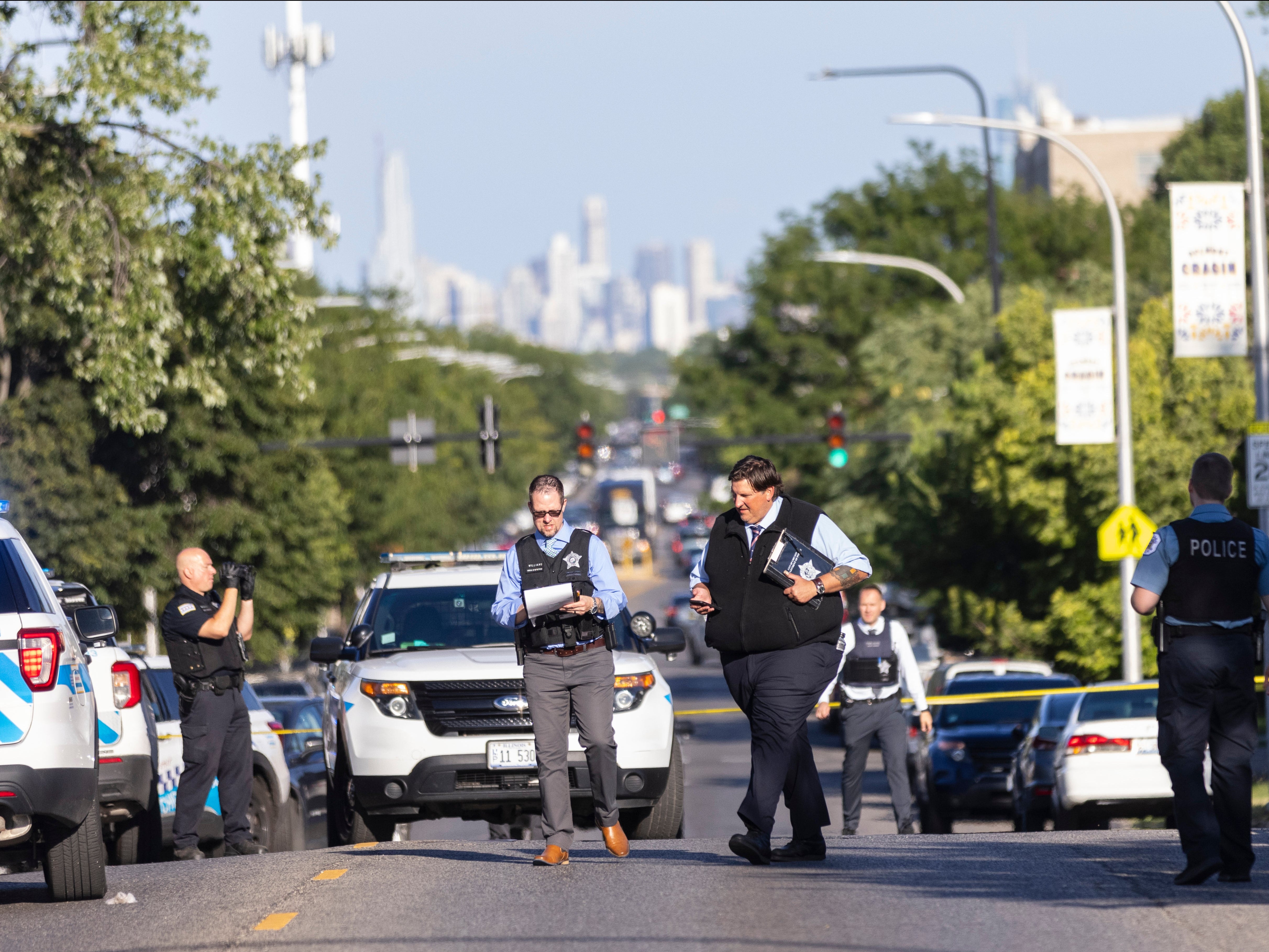 Police investigate the scene of a shooting on Sunday in Chicago