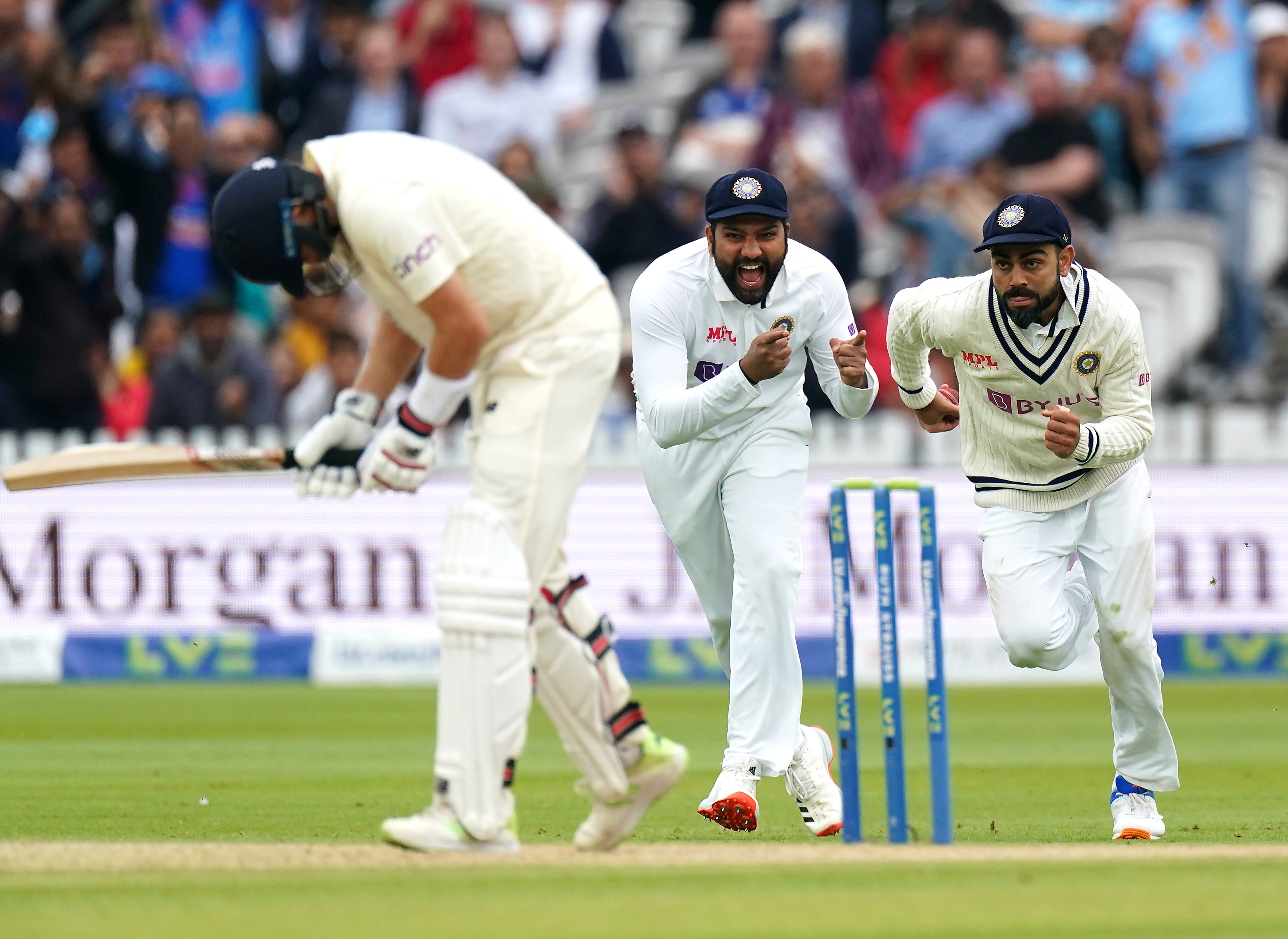 Virat Kohli, right, celebrates catching the ball to send Joe Root packing (Zac Goodwin/PA)