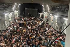 Shocking photos show 640 Afghans crammed into fleeing US Air Force plane
