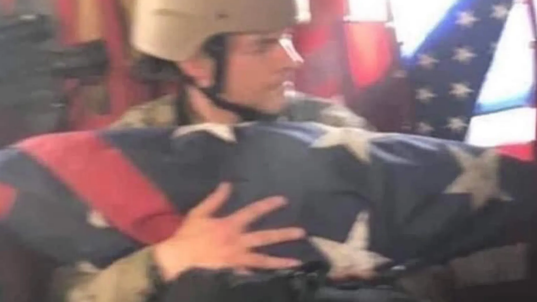 A soldier carries the American Embassy flag on Sunday after the US chaotic withdrawal