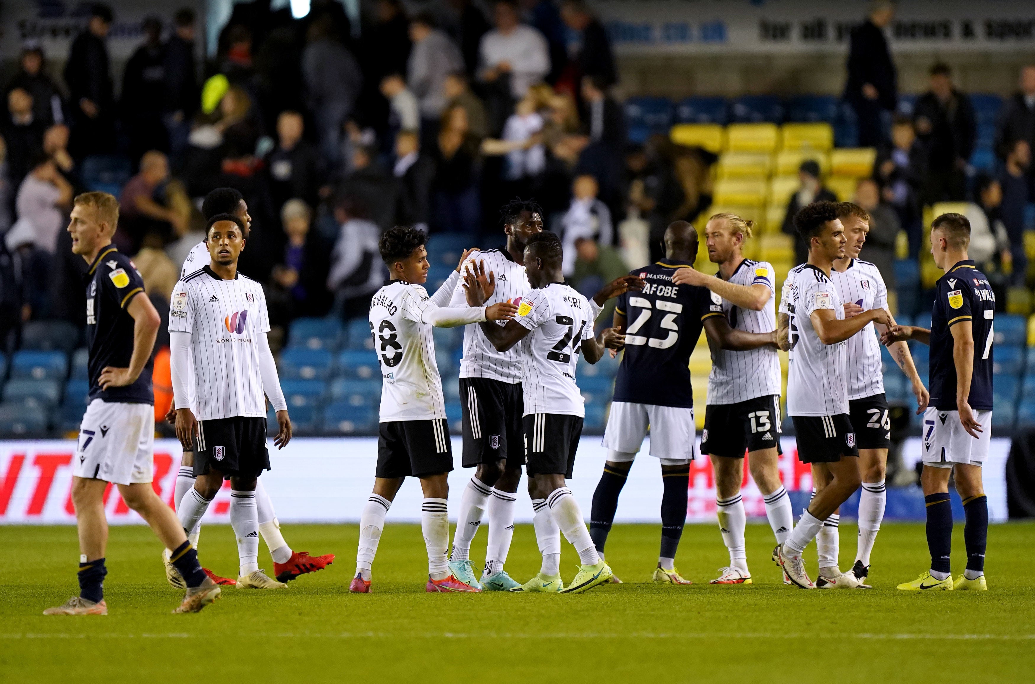 Players hug at the end of the Sky Bet Championship match at The Den