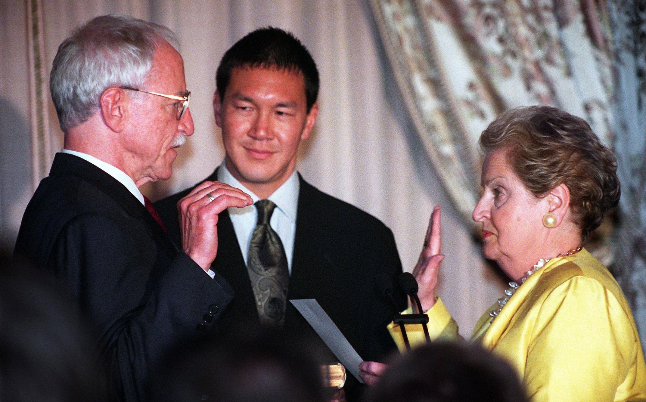 James Hormel is sworn in by Madeleine Albright and witnessed by partner Tim Wu