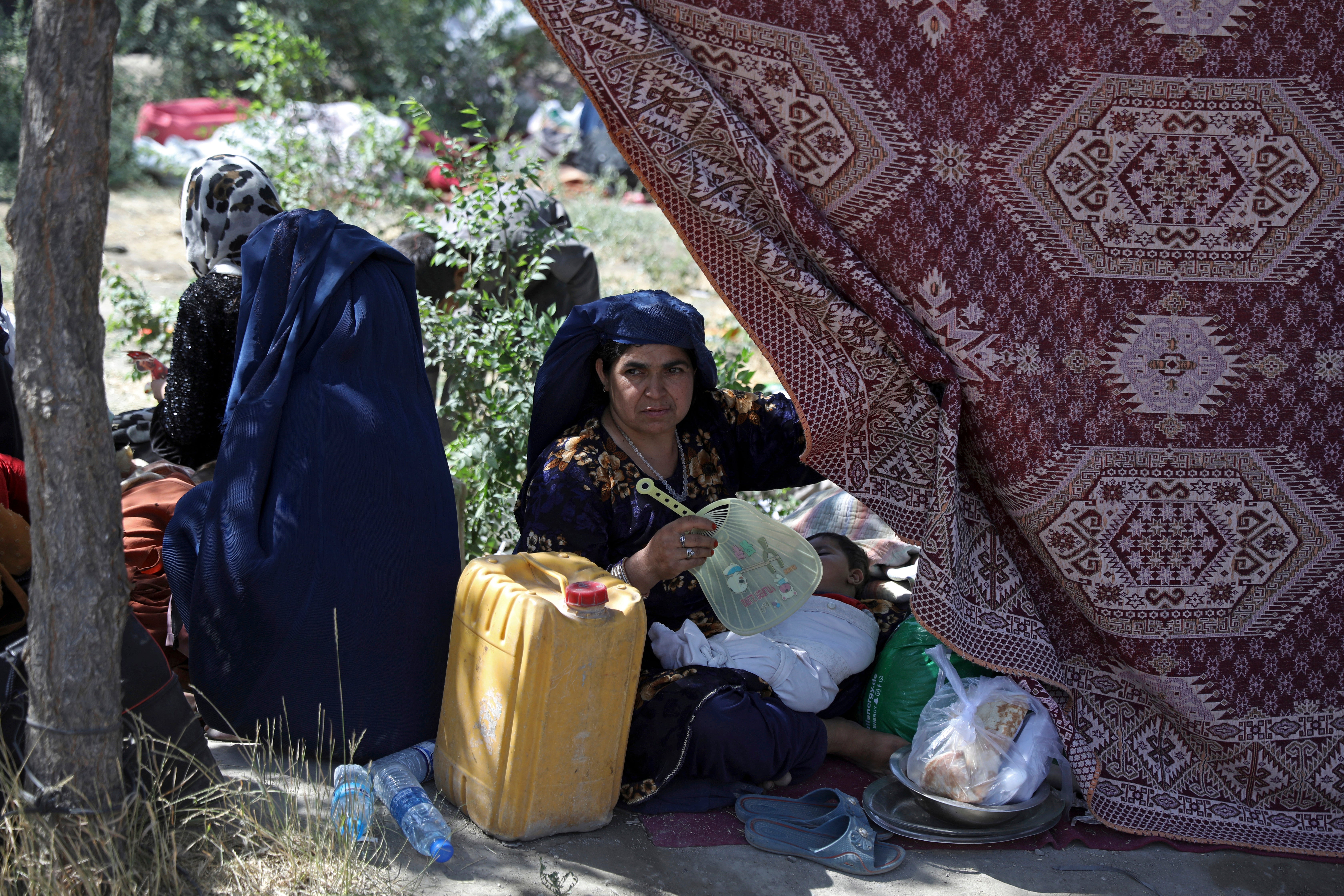 Internally displaced Afghan woman in a park in the capital of Kabul after being forced to escape her home because of conflict between Taliban and Afghan security