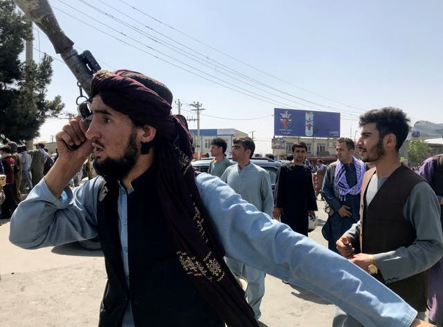 <p>A member of Taliban forces inspects the area outside Hamid Karzai International Airport. </p>