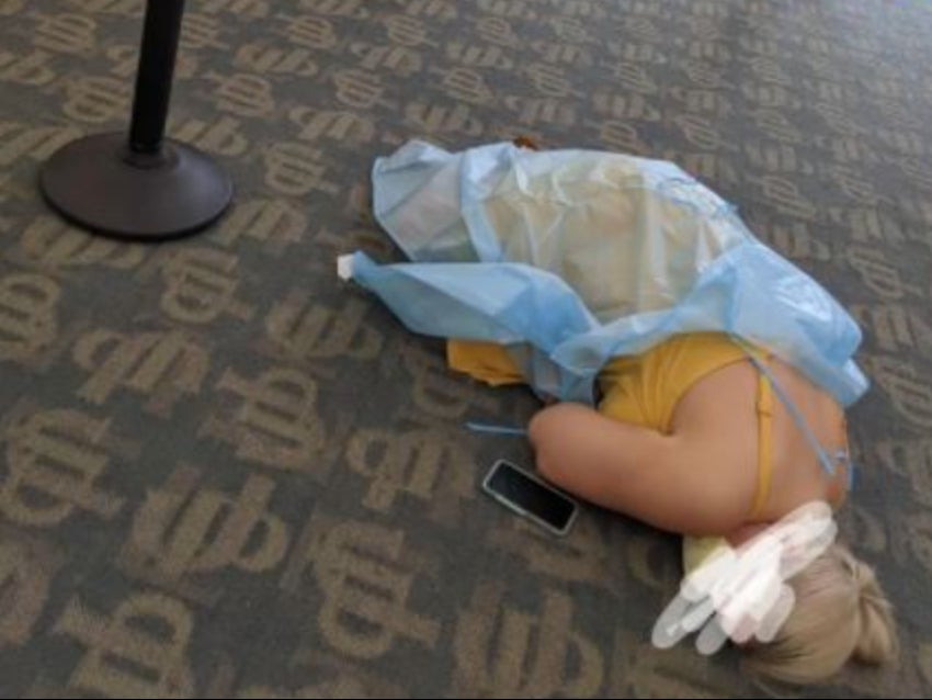 A woman suffering from Covid-19 symptoms lies on the floor of a monoclonal treatment facility in Jacksonville, Florida