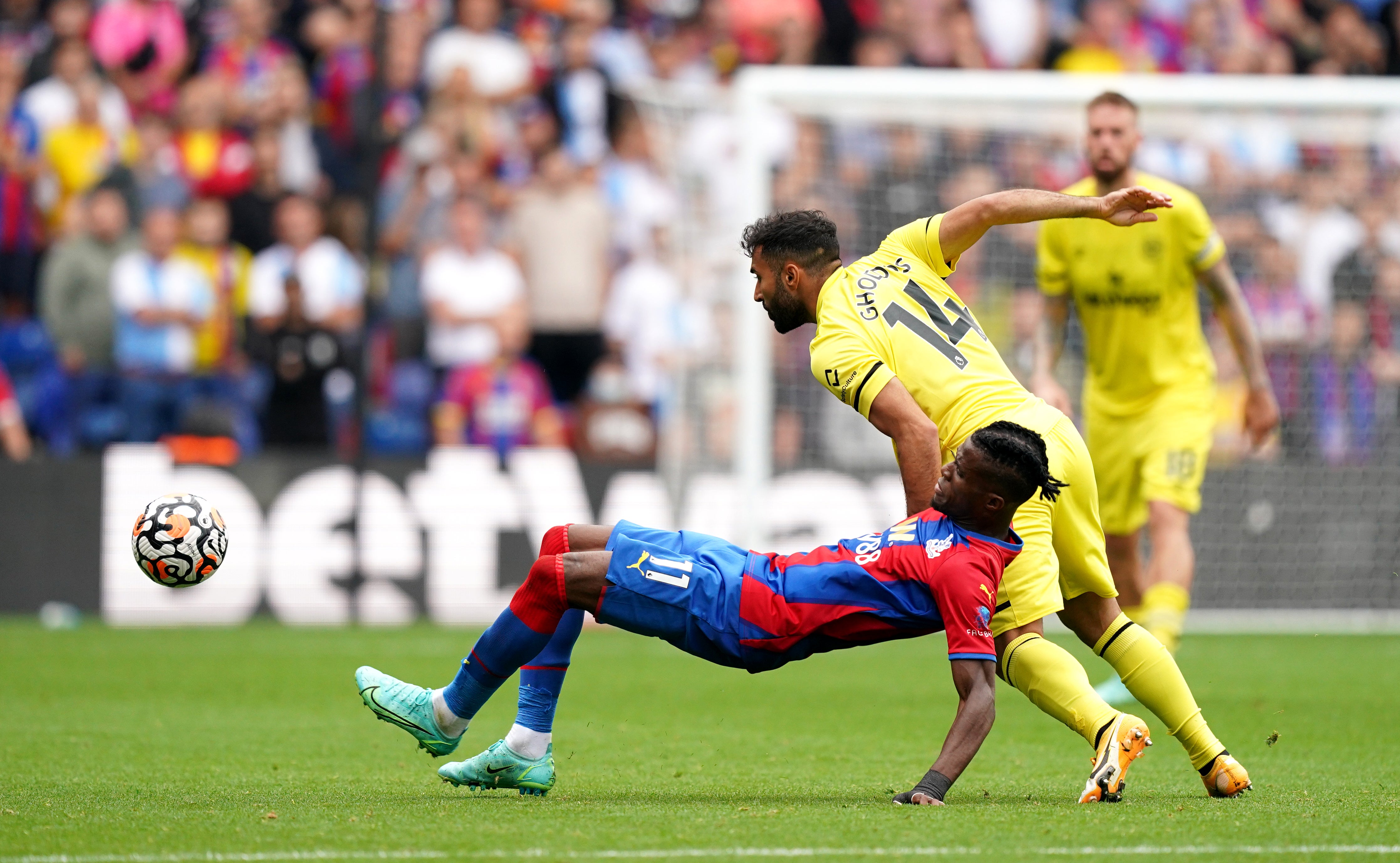 Crystal Palace’s Wilfried Zaha (left) and Brentford’s Saman Ghoddos battle for the ball (Dominic Lipinski/PA)