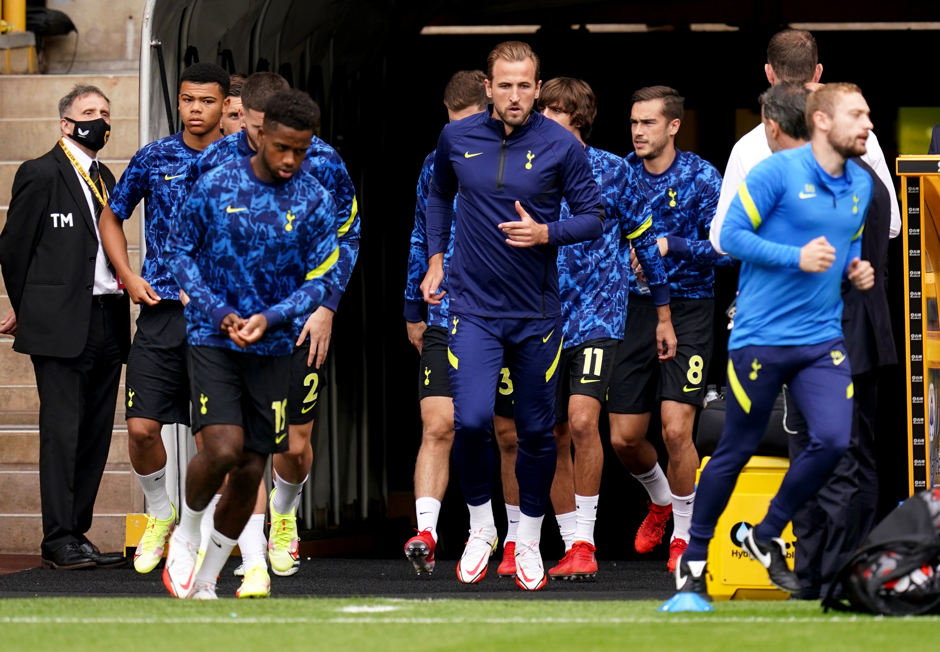 Harry Kane (centre) makes his way out onto the pitch for Tottenham’s warm up ahead of the Premier League match against Wolves at Molineux.