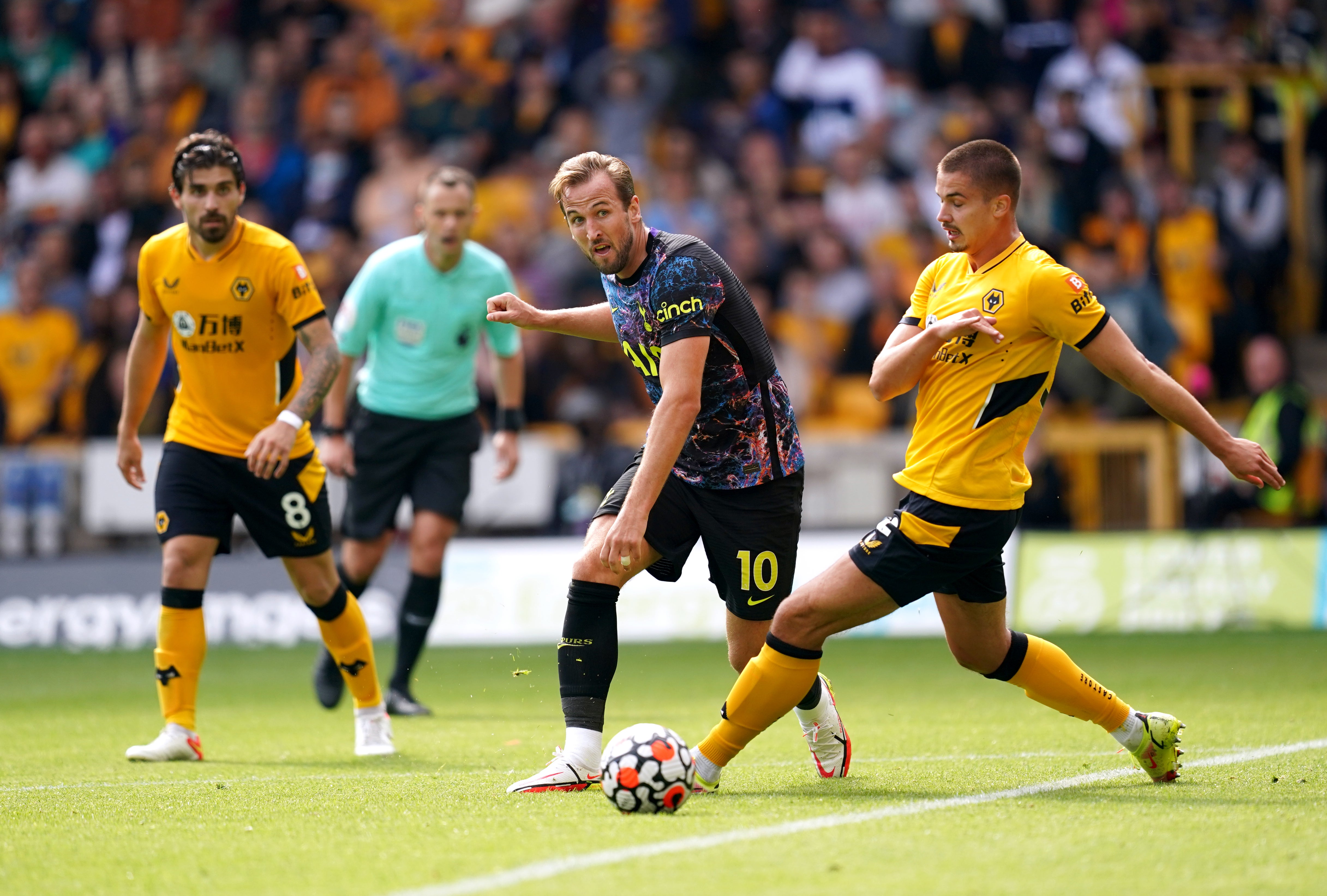 Harry Kane (left) battles for the ball with Wolves’ Leander Dendoncker at Molineux.