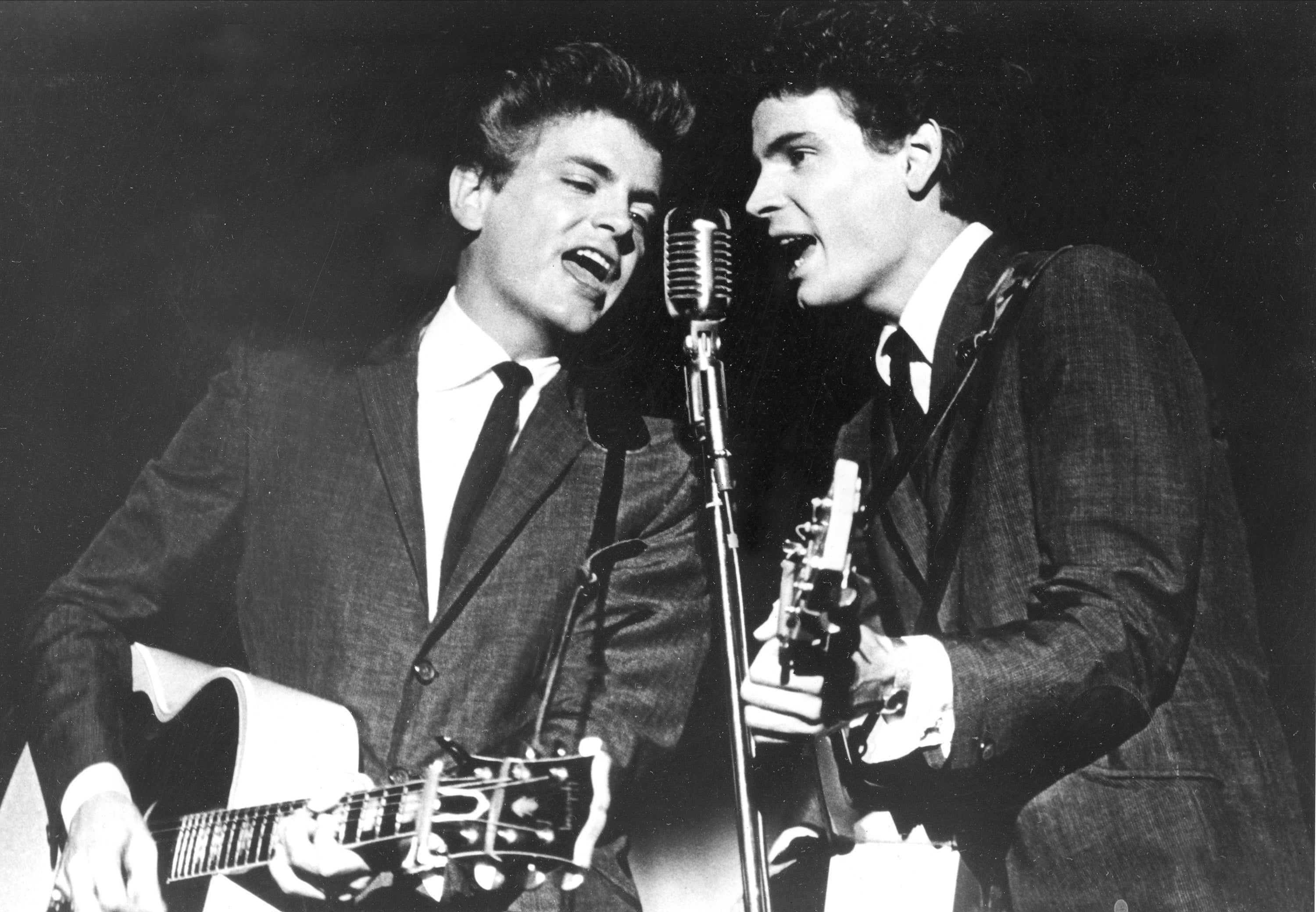 The Everly Brothers, Phil, left, and Don, perform on stage in 1964