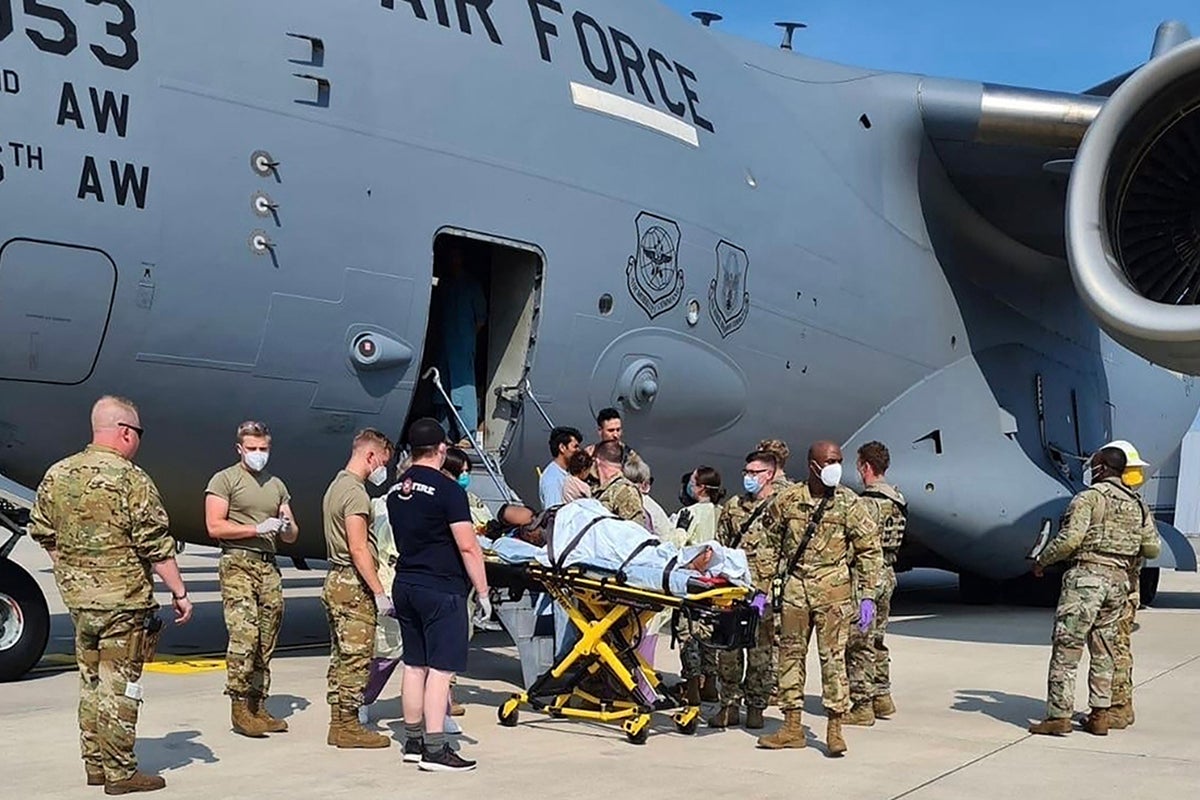 A woman is carried off a US Air Force C-17 aircraft in Germany after giving birth on board