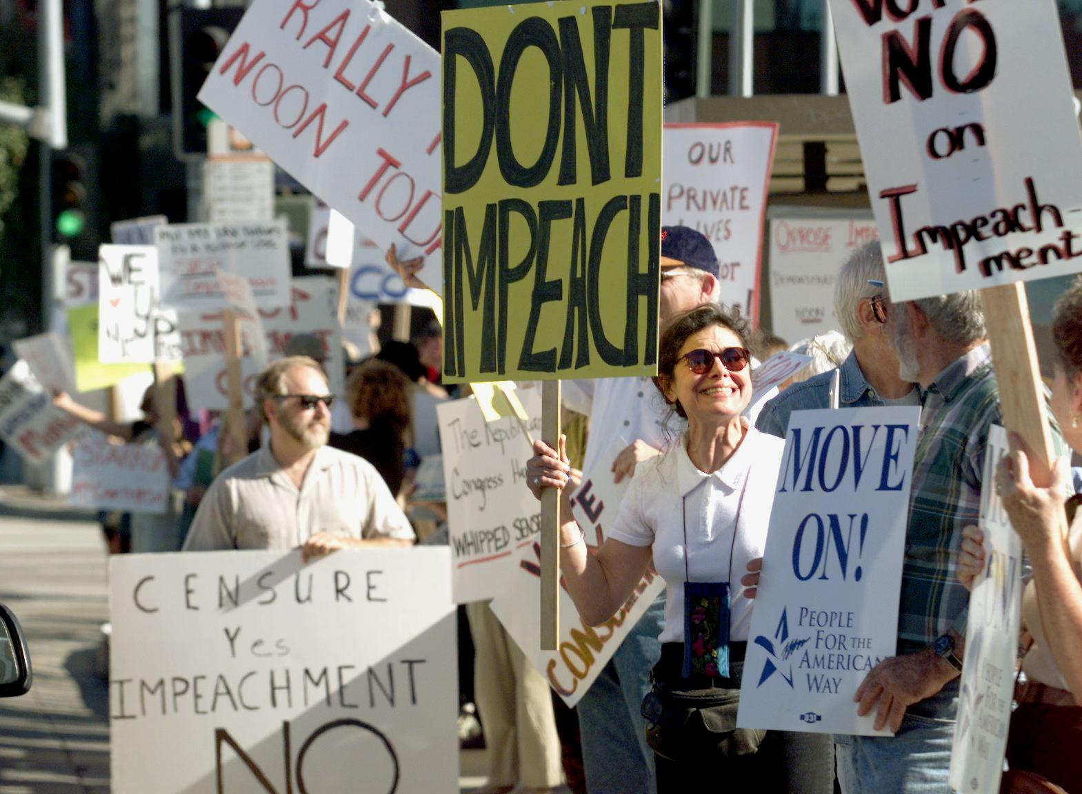 A group of people demonstrate to stop the impeachment process against Bill Clinton on 16 December 1998