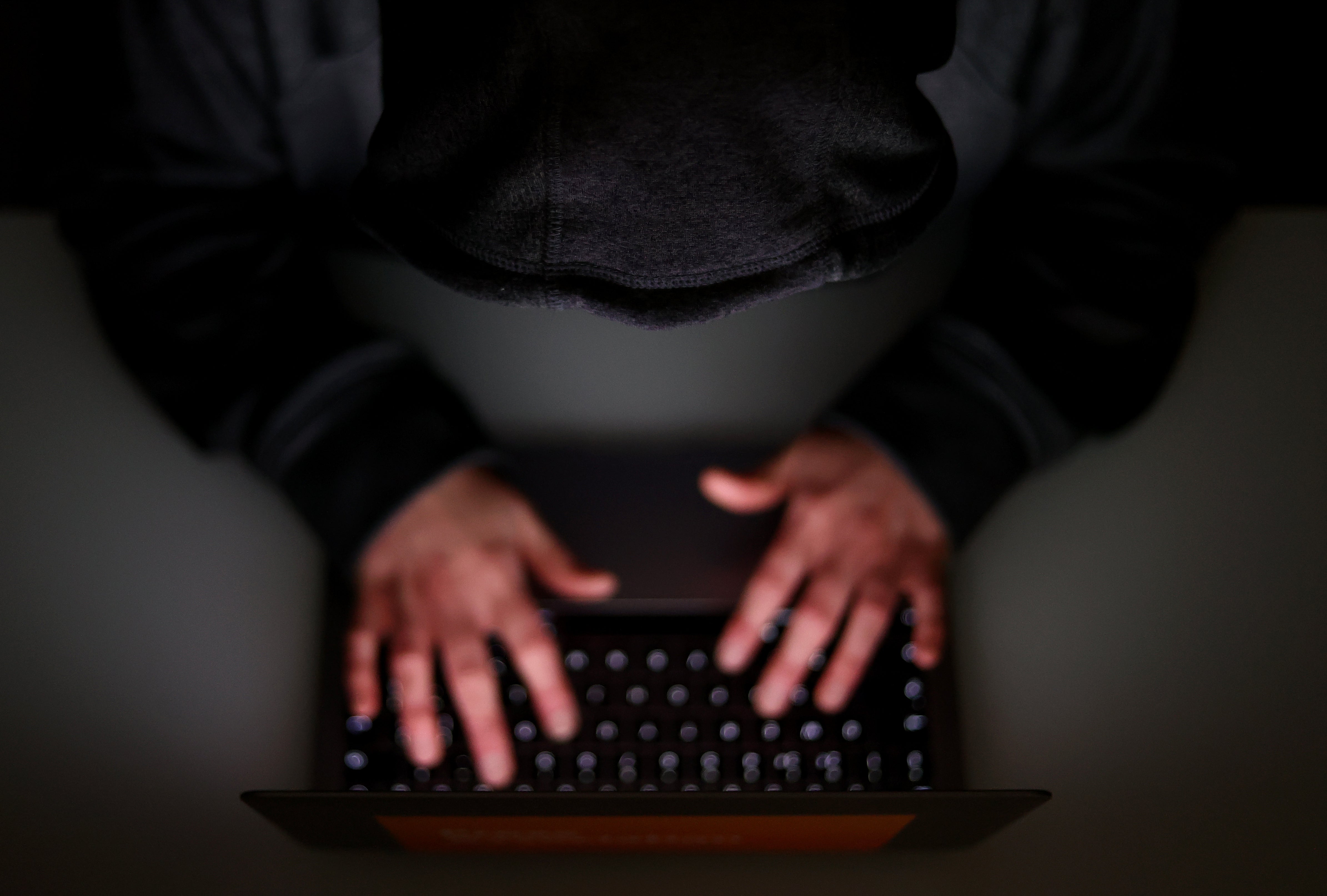 A laptop user with their hood up (Tim Goode/PA)