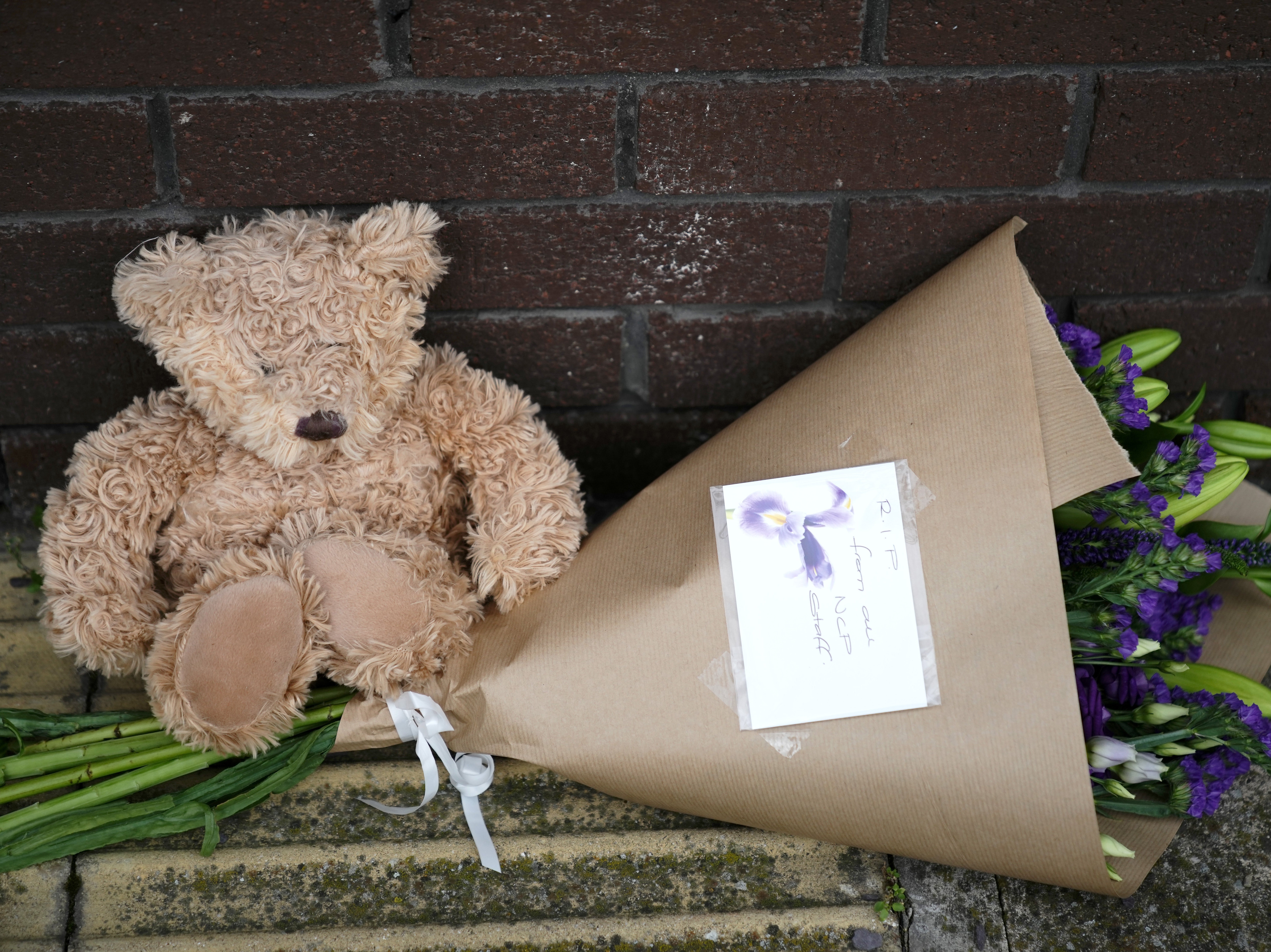 A teddy bear and flowers lay outside the OYO Metropolitan Hotel in Blonk Street, Sheffield, where a five year old Afghan refugee boy fell to his death from a window