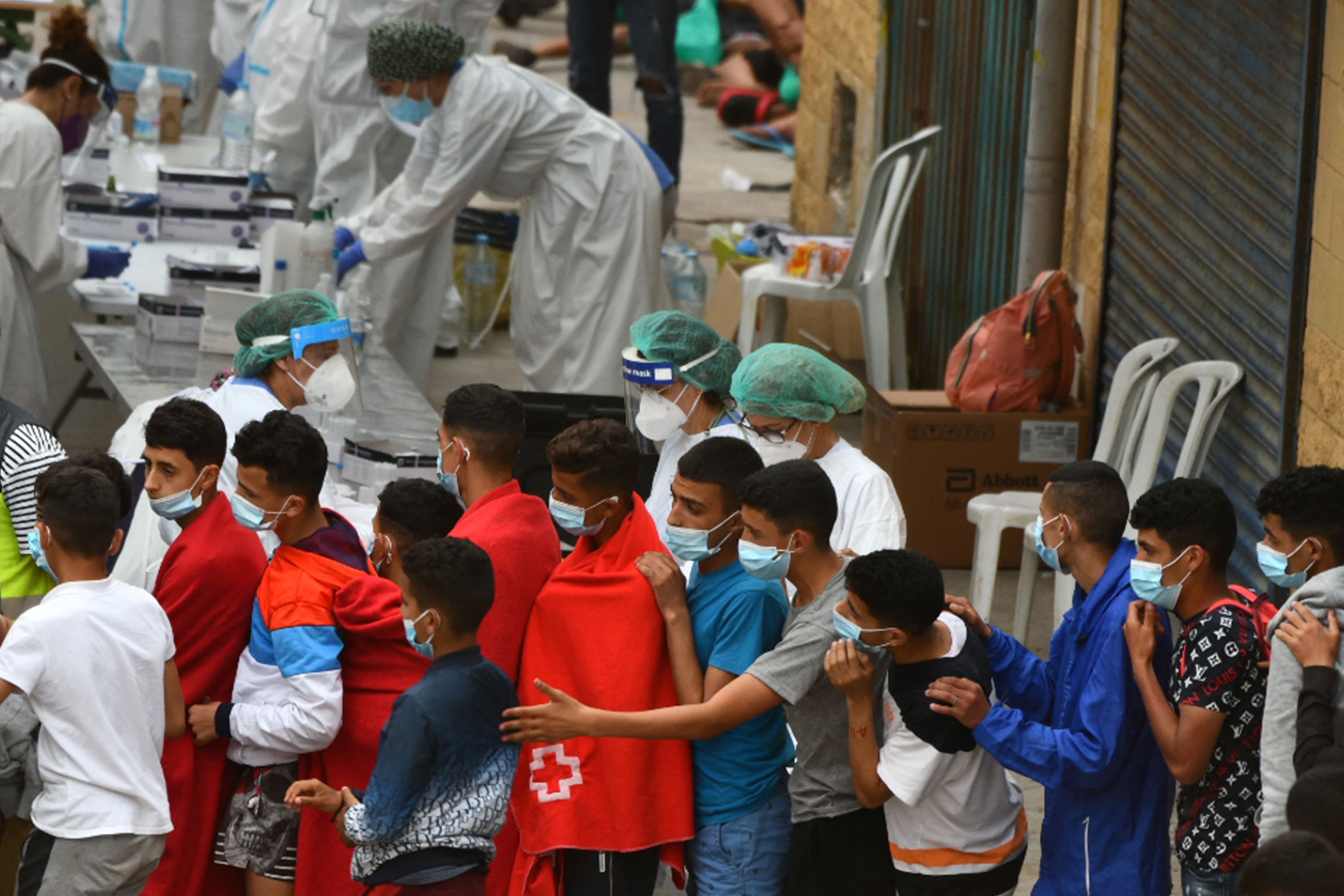 Migrants aged below 18 wait to be tested for Covid-19 upon their arrival in the Spanish enclave of Ceuta in May